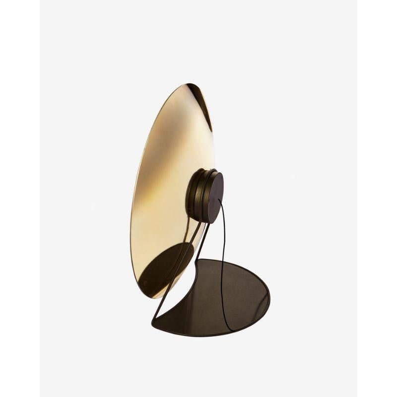 Zénith table light, gold & large by RADAR.
Design: Bastien Taillard
Materials: Thermoformed gold glass, built-in light dimmer, magnetic cord. Lacquered metal structure with black matte finish.
Dimensions: depth 40 x diameter 70 cm

Also
