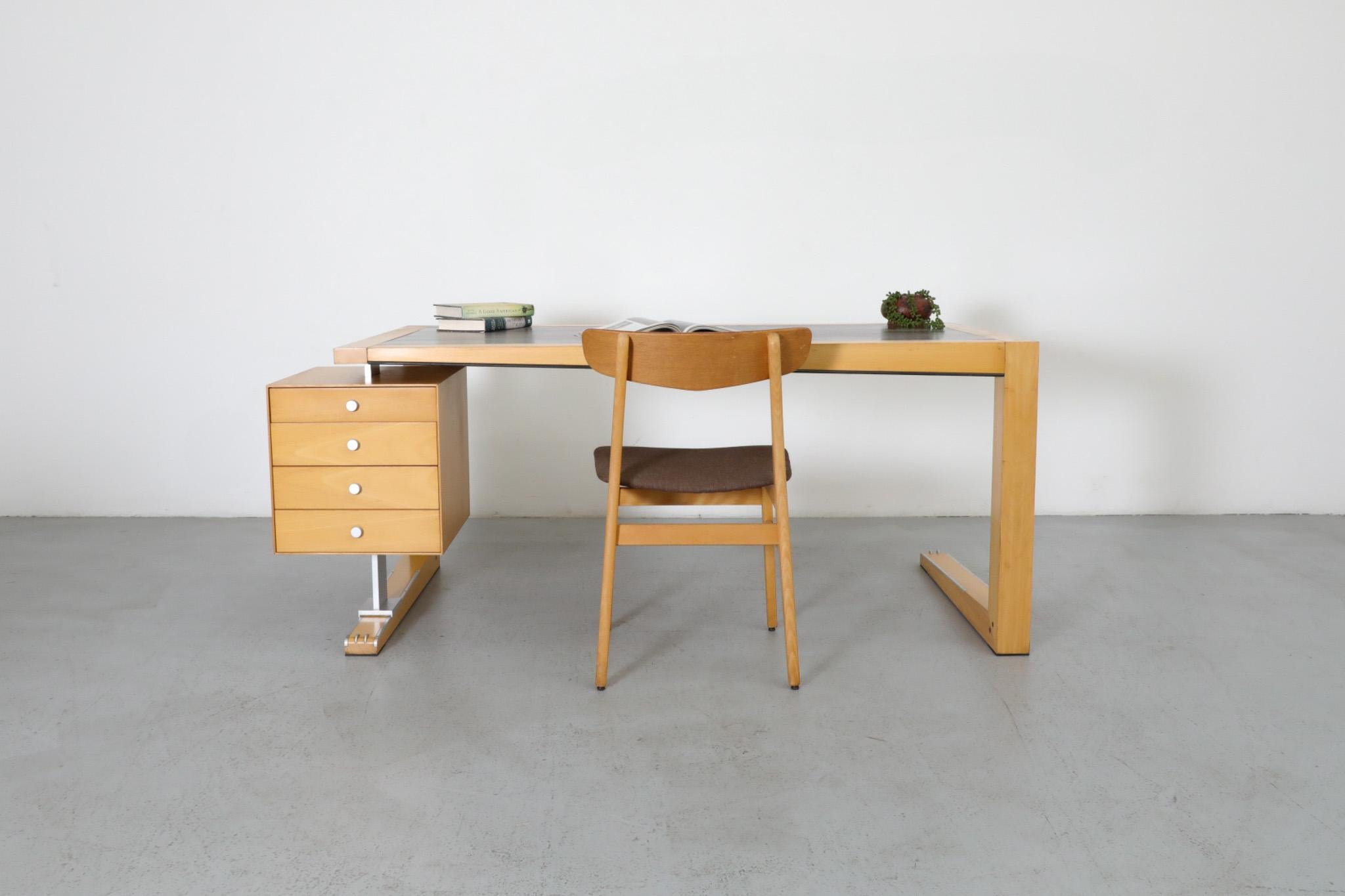 A well crafted asymmetric 90's desk designed by Massimo Scolari for Giorgetti S.p.A. The desk is made of a beech frame with Macassar Ebony inset top and aluminum hardware. The leg has a floating 4 stack of drawers. Drawers measure: 16