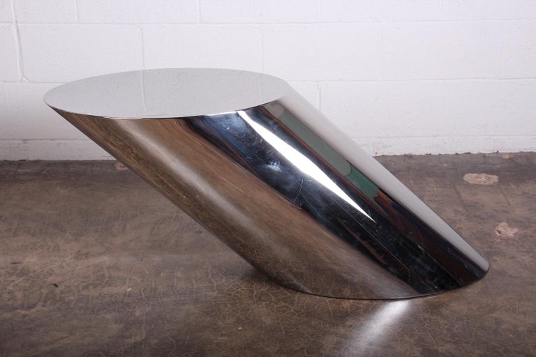 A large polished steel cantilevered table with weighted base. Designed by J. Wade Beam for Brueton.