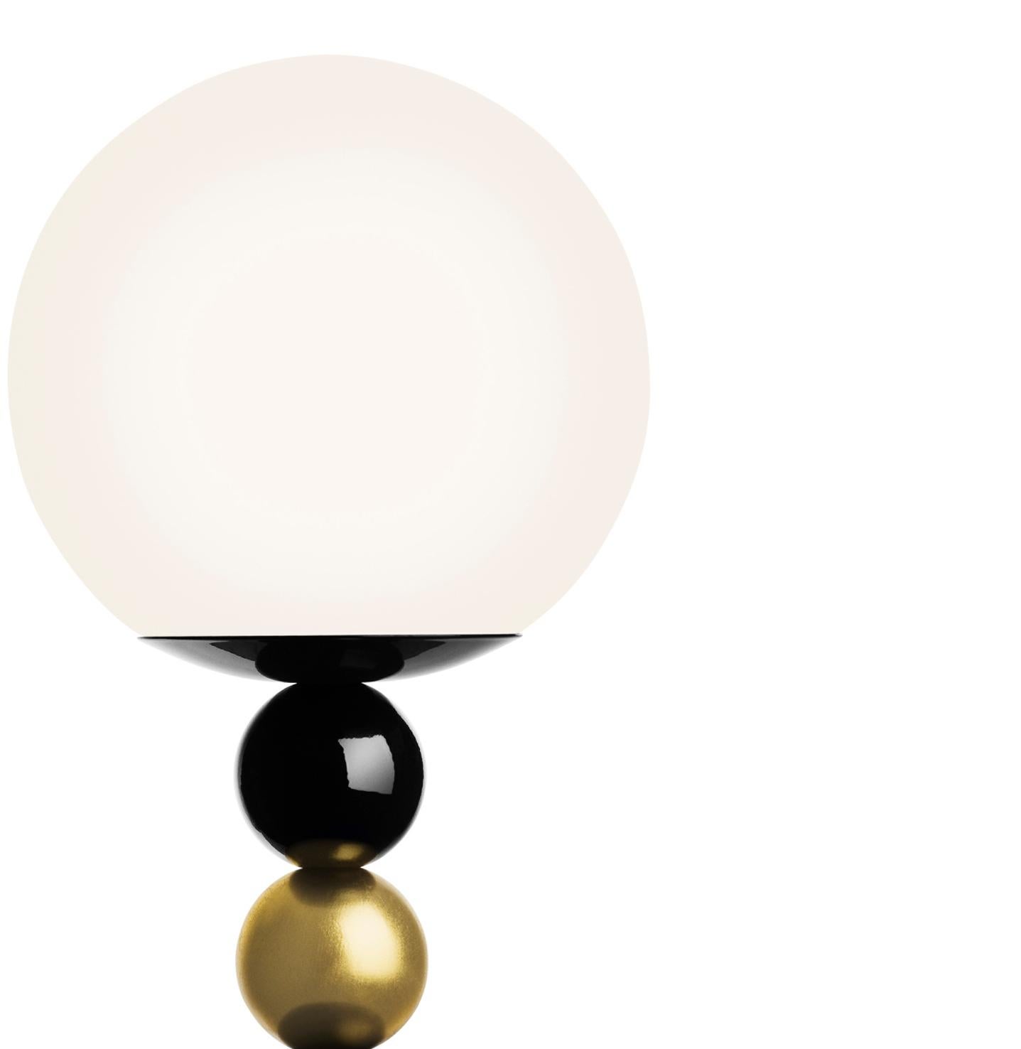 Fredrik Mattson took the idea of “lighting as jewelry” very seriously when designing his RGB floor lamp with its stacked wooden balls painted in glossy shades of black, green and gold (or all black). Punctuated with a white glass globe, the fixture