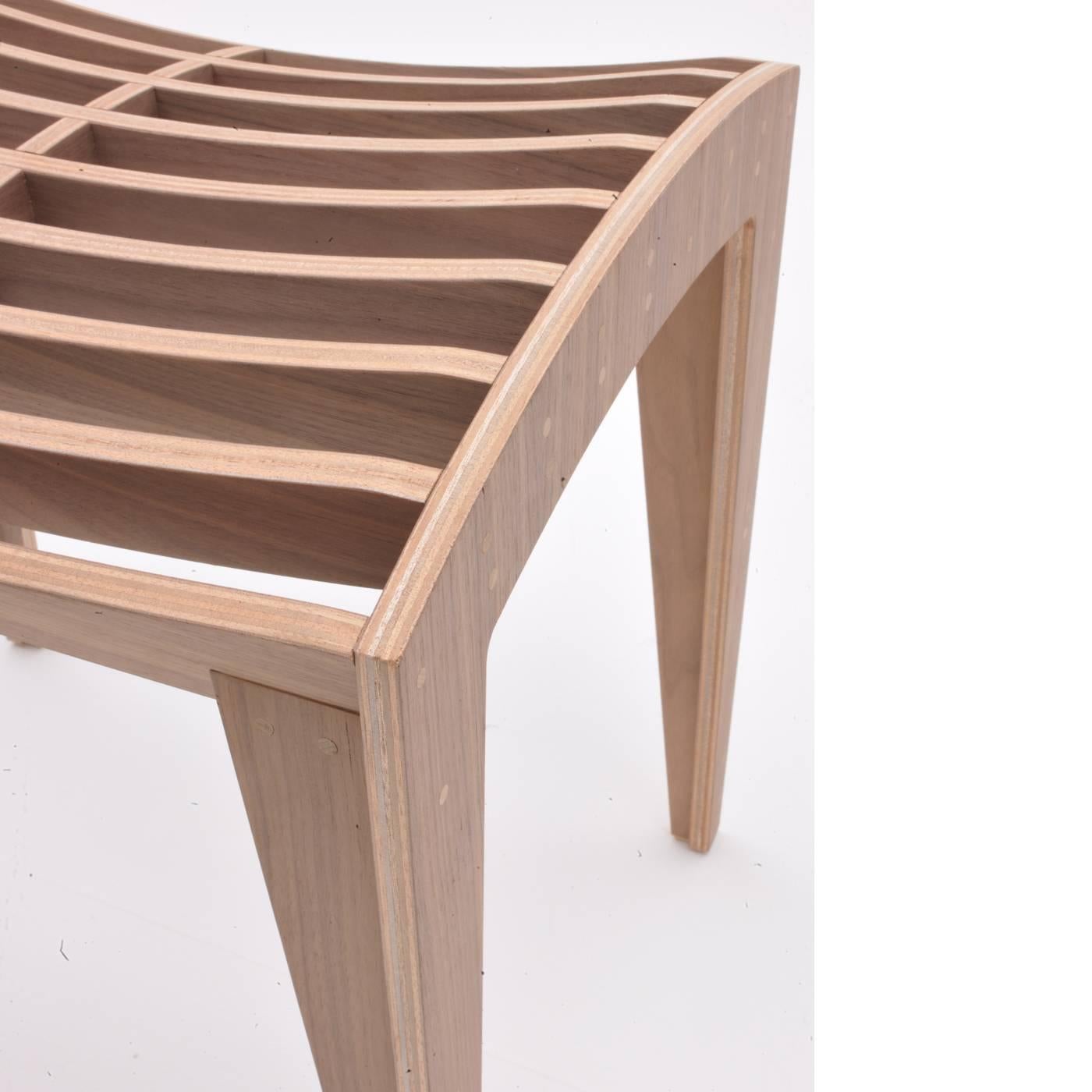 This striking piece was designed by Franco Poli for Morelato and it is the harmonious result of the mix between design and ideal choice of material. The seat is made of lists of wood assembled by single joints and pins and features a curved surface