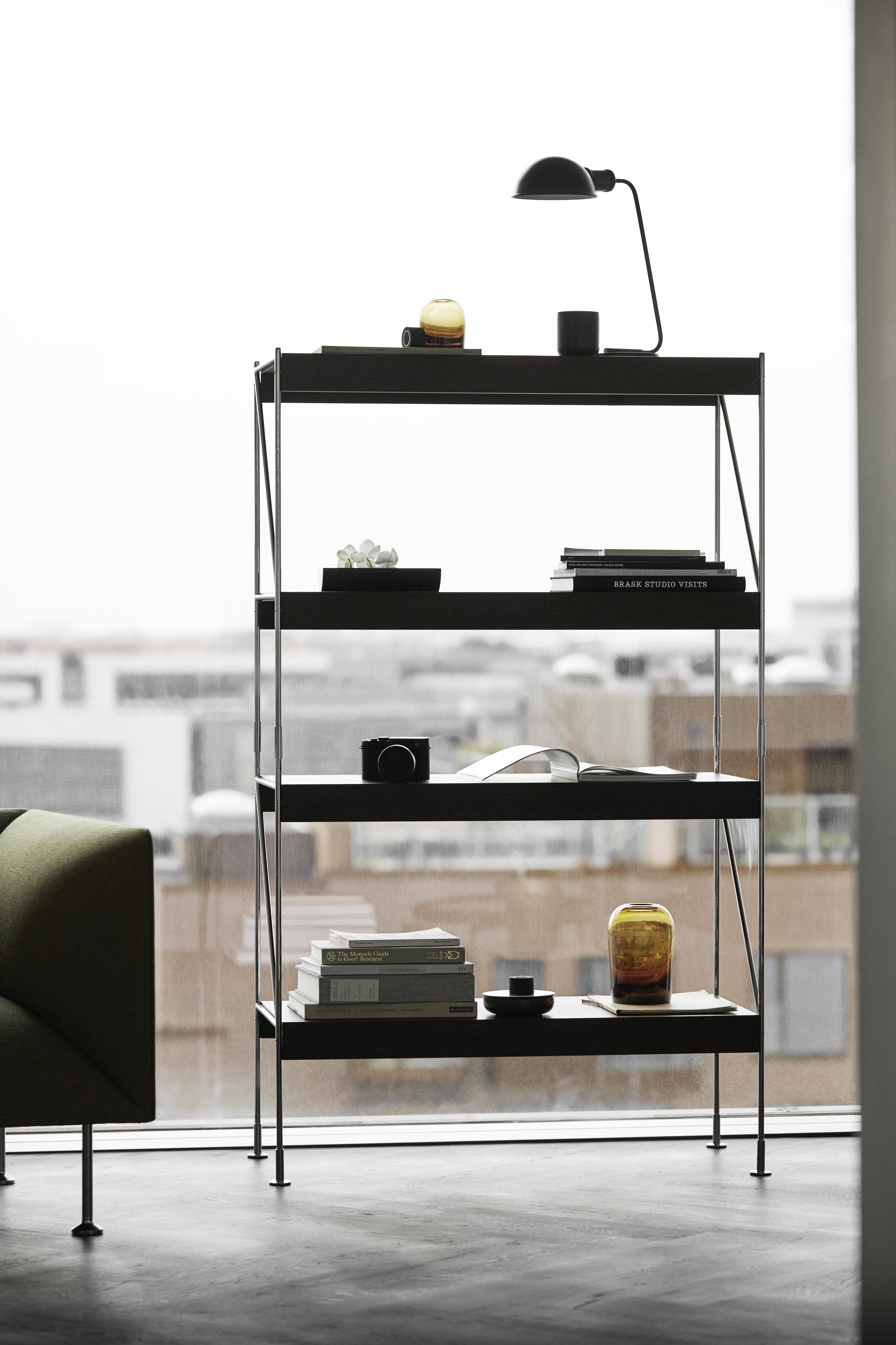 Zet is a smart shelving system with a light, airy, and minimalistic appearance. The whole system consists of two components only: the wooden U-shaped shelves and the metal frame construction. By assembling those two parts, you are able to build