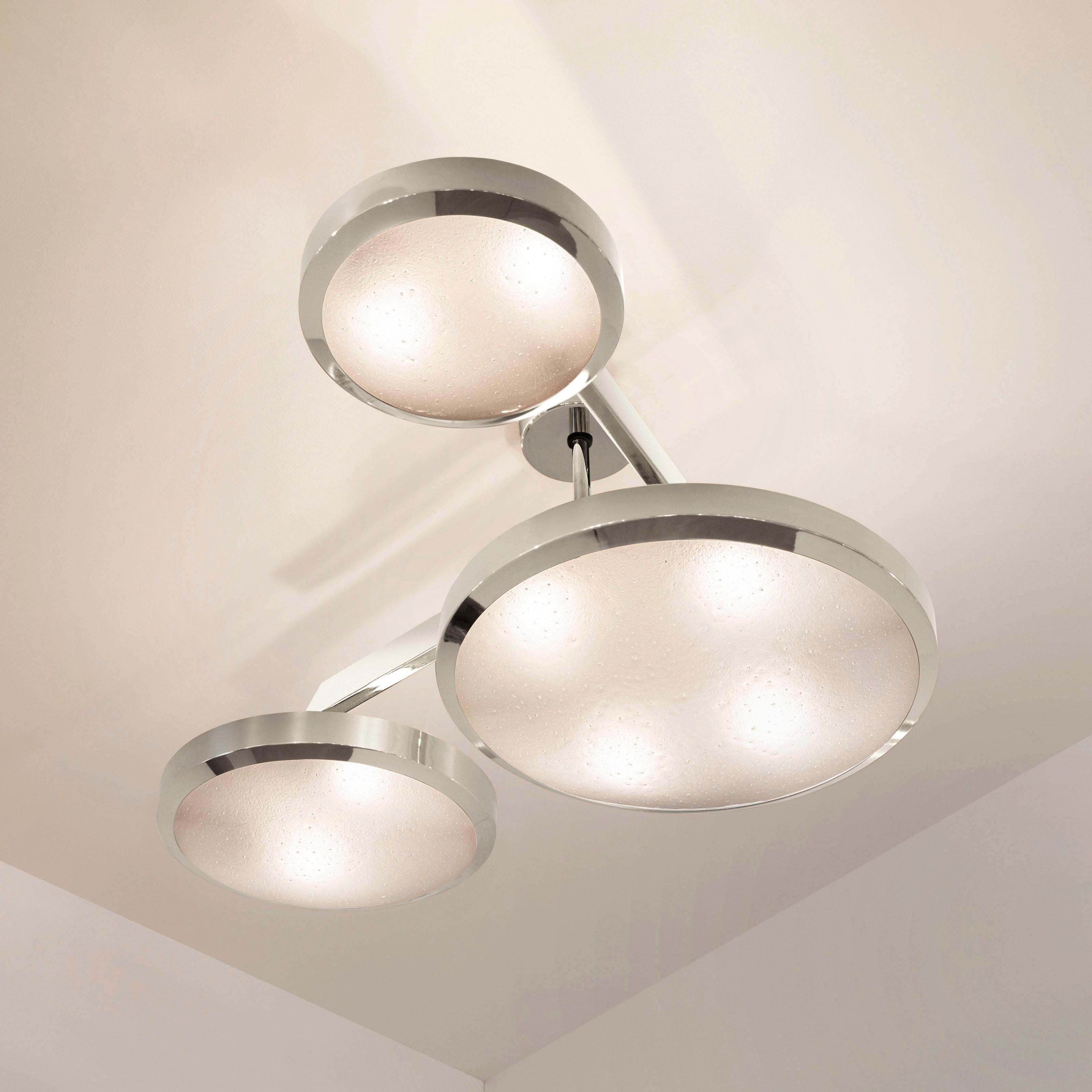 The Zeta ceiling light by form A features a composition of variable sized Murano glass shades methodically balanced on a “V” shaped brass frame. The first images show the fixture in our polished nickel finish-subsequent pictures show it in a