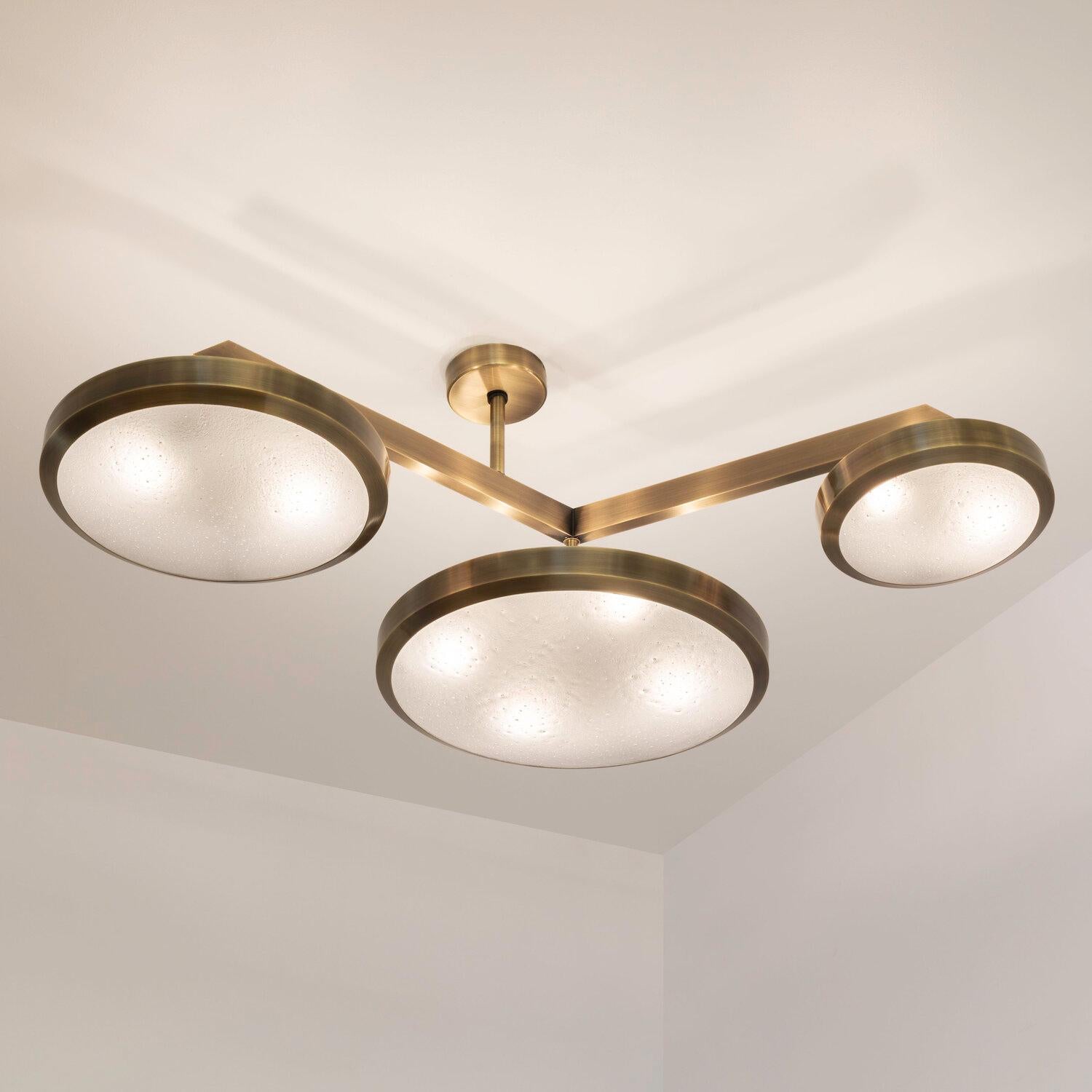 The Zeta ceiling light features a composition of variable sized Murano glass shades methodically balanced on a “V” shaped brass frame. The first images show the fixture in our bronzo ottone (bronze) finish-subsequent pictures show it in a selection