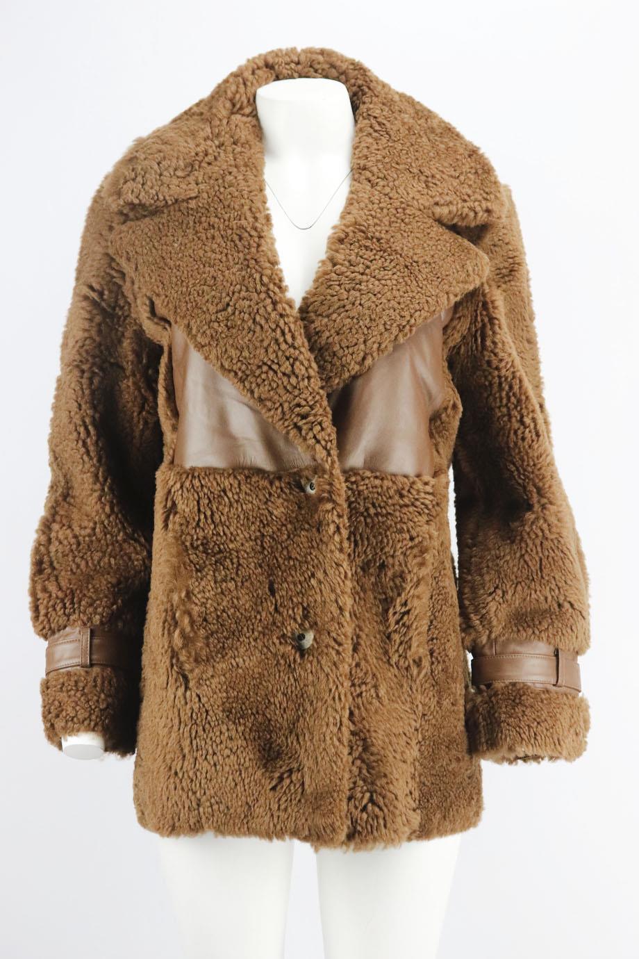 Zeynep Arcay leather trimmed shearling coat. Brown. Long sleeve, v-neck. Button fastening at front. 100% Lambskin wool. Size: FR 34 (UK 6, US 2, IT 38). Shoulder to shoulder: 17 in. Bust: 40 in. Waist: 38 in. Hips: 40 in. Length: 30 in
