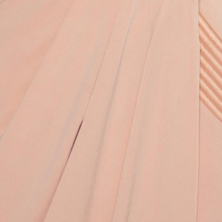 This Zhivago dress is a masterpiece. Channeling a strong shoulder pad look, the midi dress is crafted from knit fabric and comes in a lovely shade of beige. This 'Eye of Horus' dress has a draped silhouette, faux-wrap style and broad trims that