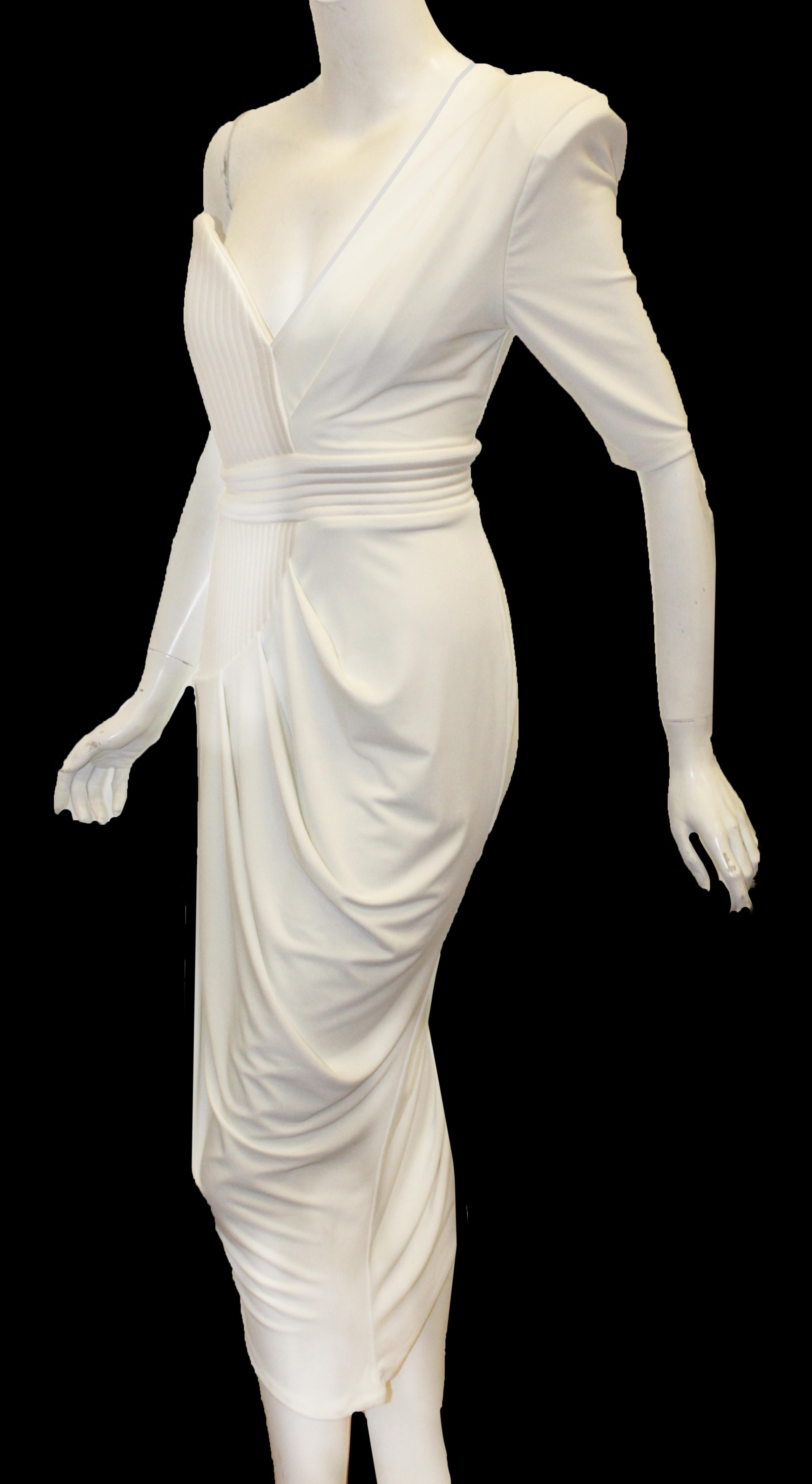 Zhivago white one padded shoulder dress incorporates ruched side details on bodice and, also, on the skirt of dress.  With quilted vertical stitched accents on the strapless side down to the hip that includes a quilted horizontal attached belt.  For