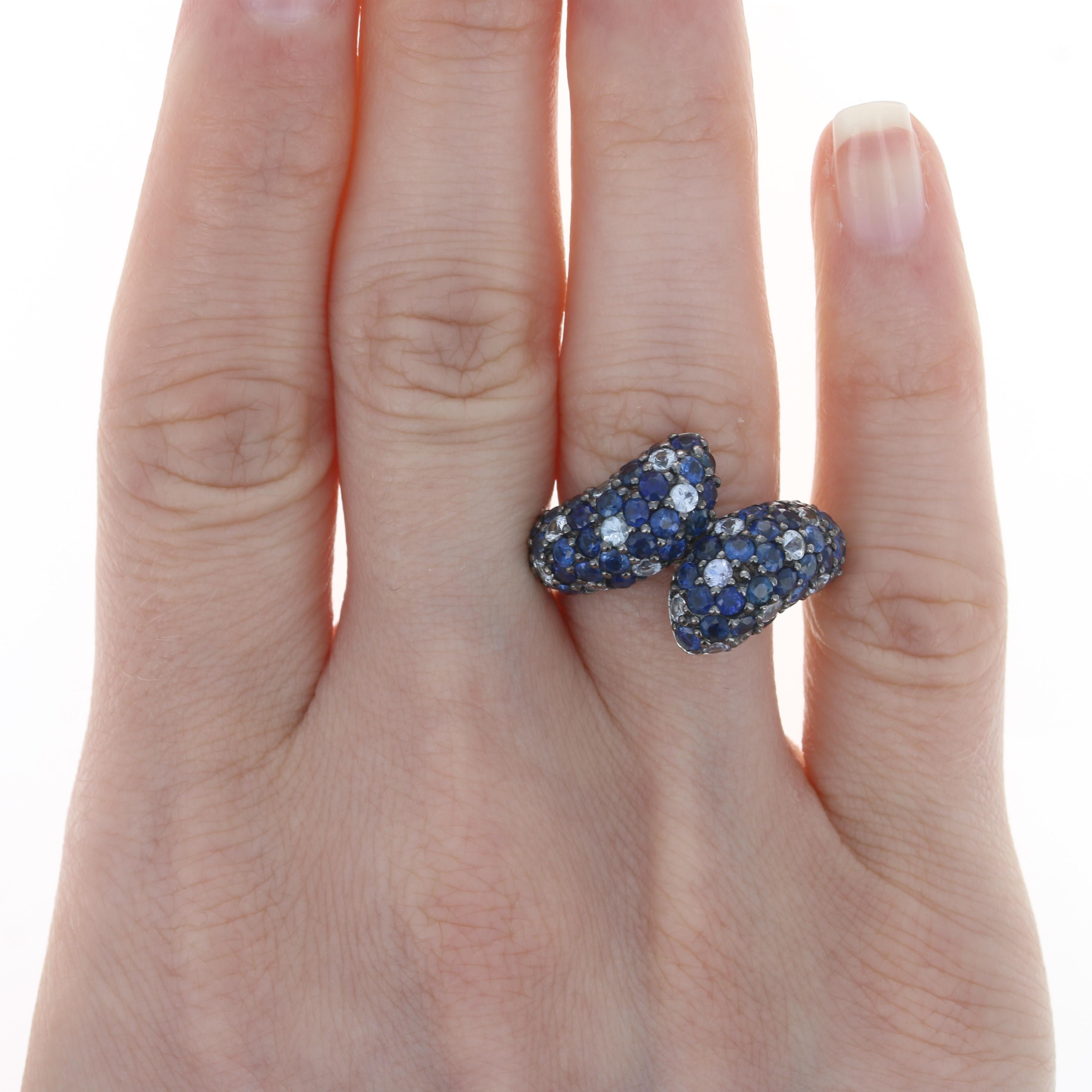 Retail Price: $1,447.50

Size: 7

Brand: Ziba by Le Vian

Metal Content: Sterling Silver

Stone Information
Genuine Sapphires
Treatment: Heating
Total Carats: 4.65ctw
Cut: Round
Colors: Blue & White

Style: Cluster Bypass

Measurements
Face Height
