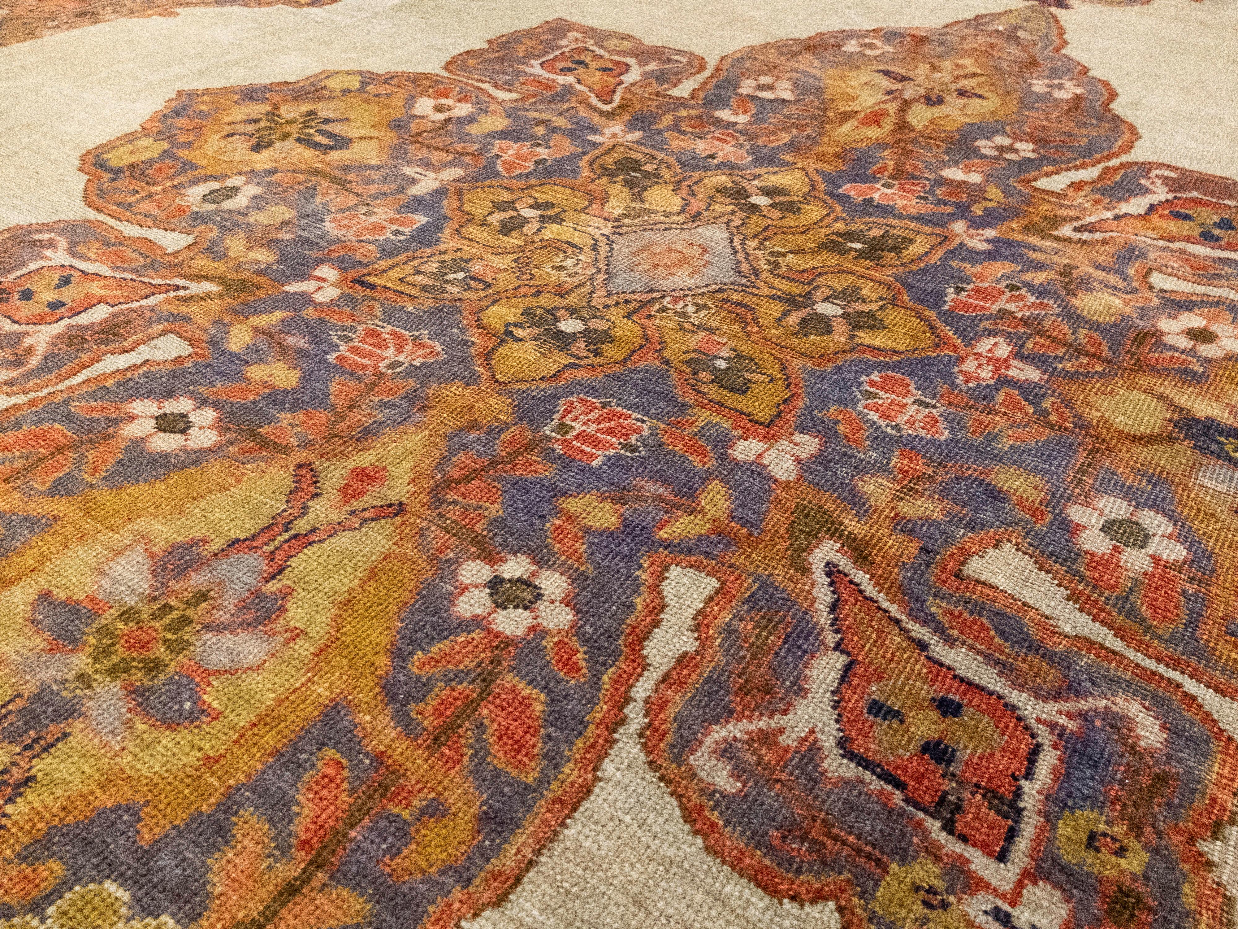 This is a uniquely patterned antique Ziegler Mahal rug. The pile is made with hand-spun wool and it has a cotton foundation. It has the Ziegler Mahal traditional feature of a large ornate floral center and is surrounded by several individually
