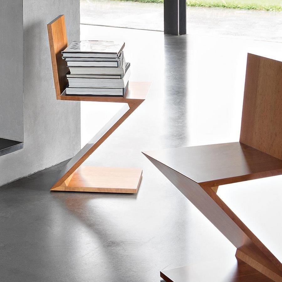 The Zig-Zag chair (1934) by Dutch designer Gerrit Thomas Rietveld is one of the earliest examples of a cantilevered solid wood chair. Its four wood boards are connected end to end, giving the structure the appearance of a Z-shaped puzzle. This