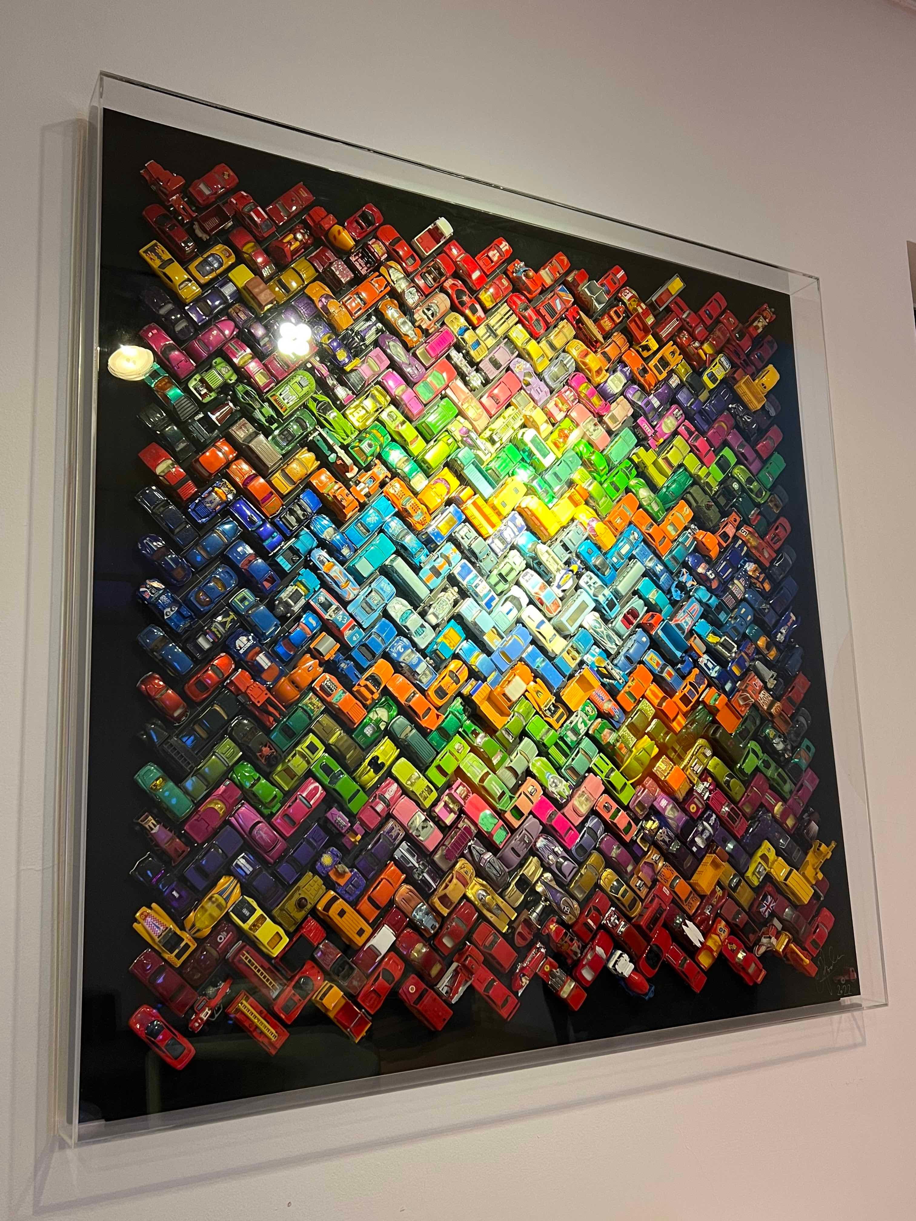 Unique sculpture comprising a selection of vintage toy cars in a joyous explosion of colour.
In perspex box-frame
Signed and dated lower right
NB: Installation is extremely easy: the sculpture is secured to the wall by a split baton, and the perspex