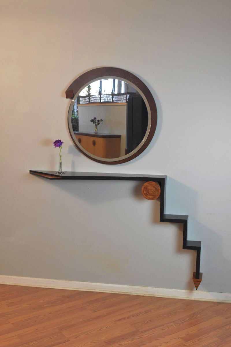 This vintage wall shelf set is made of Ebony and figured Makore Veneers with black line detailing. The Mirror has a crackle lacquered finish with a Mahogany tip detail. Inspired by the Art Deco movement, this elegant piece will help elevate any