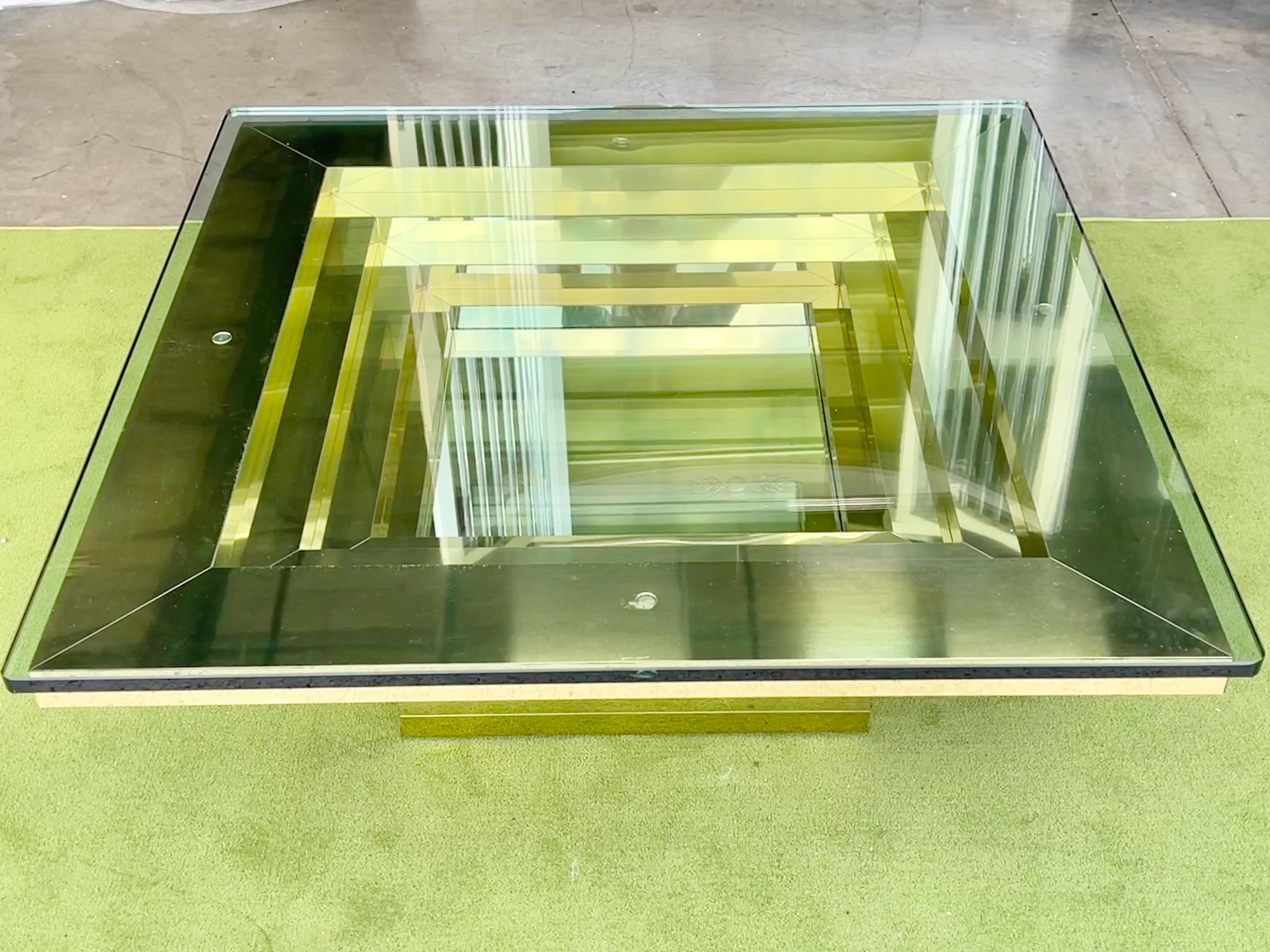 Ziggurat brass clad cocktail table in stepped inverted pyramid design with 0,75 inch thick glass top, USA circa 1983.
Interior well clad in mirror polished stainless steel.
Glamorous 80's 'cocaine decor'
Maker unknown.  Previously we had a larger