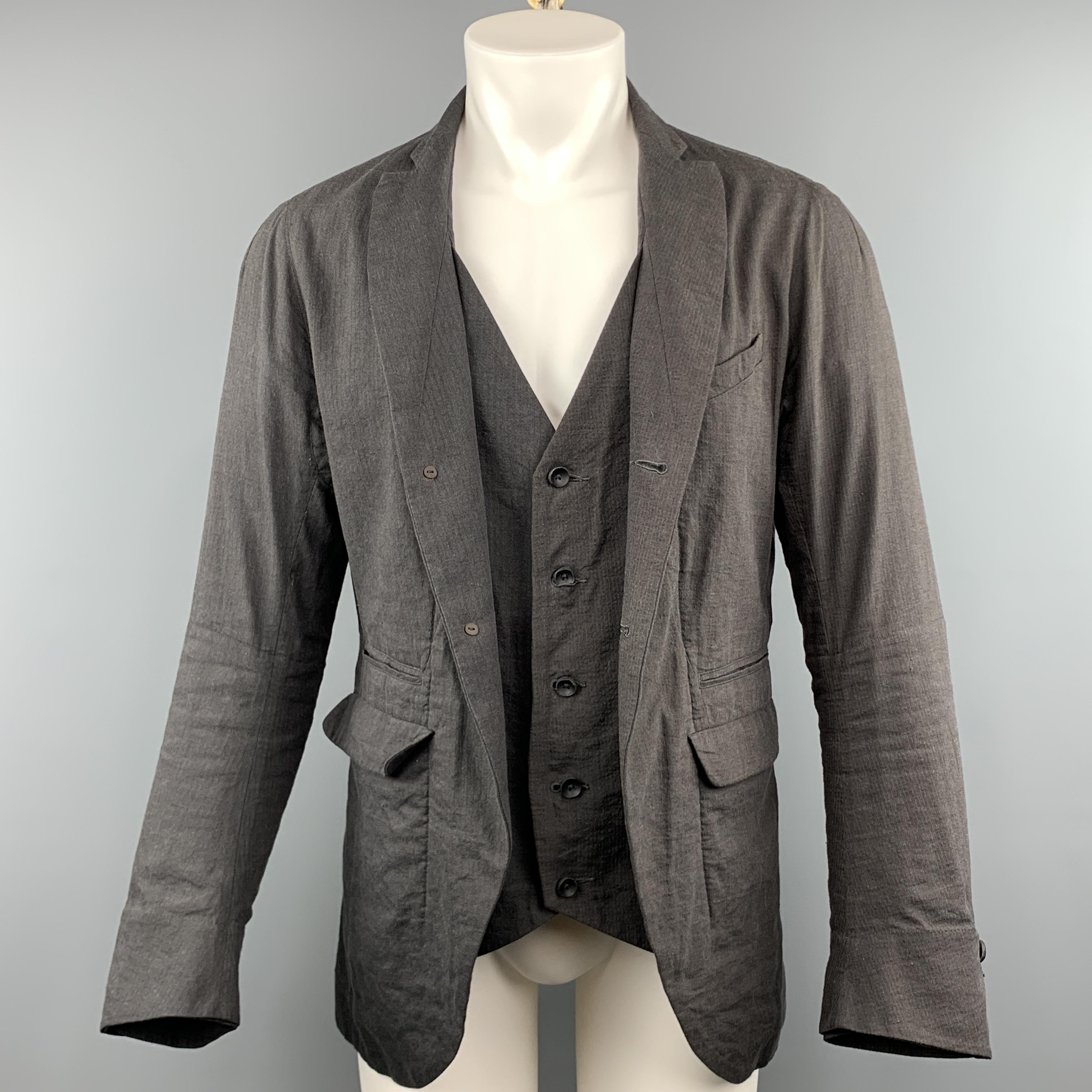 ZIGGY CHEN jacket comes in a charcoal textured cotton and linen featuring a notch lapel style, simulated vest layer, flap pockets, and a buttoned closure.
 
Very Good Pre-Owned Condition.
Marked: 48
 
Measurements:
 
Shoulder: 17.5 in.
Chest: 38
