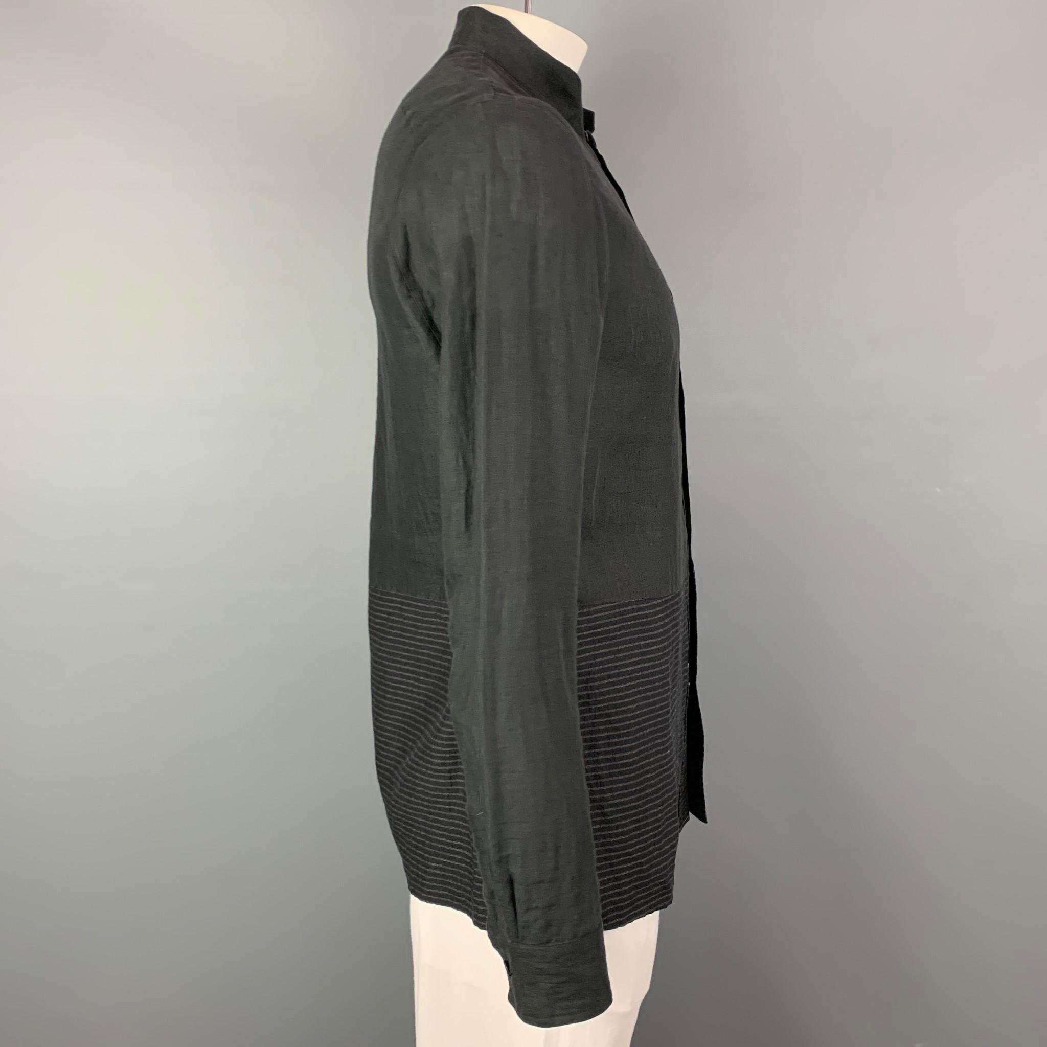 ZIGGY CHEN S/S 15 long sleeve shirt come sin a slate cotton / linen with a striped bottom trim featuring a band collar, front pocket, and a buttoned closure. 

Very Good Pre-Owned Condition.
Marked: 46
Original Retail Price: