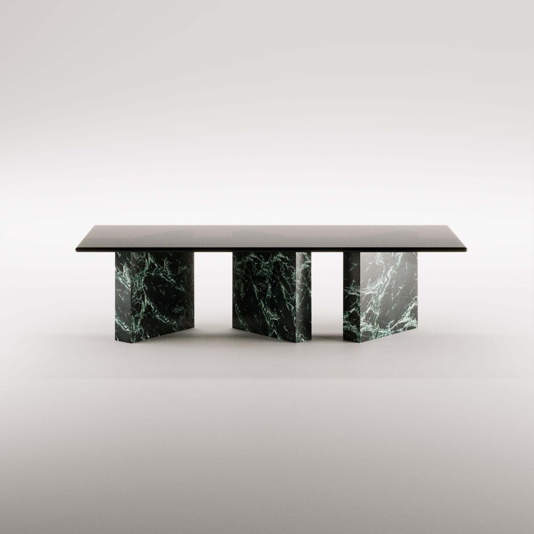 Enhance your dining space with the Zigi Dining Table, a captivating piece crafted from exquisite Spider Green marble. This stunning table displays deep green hues woven with striking white veins, creating a bold yet harmonious interplay that brings