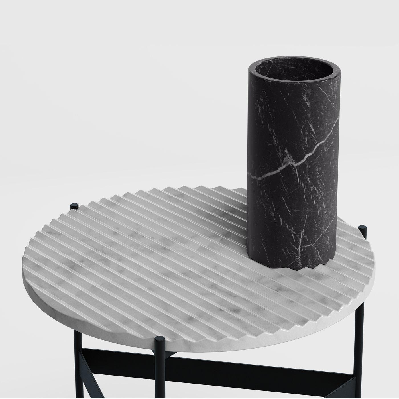 The epitome of contemporary taste, this sculptural vase fashioned of prized black Marquina marble showcases a sleek zig-zagged base designed to interlock with its counterpart marking the coffee tables from the ZigZag series. Stunning as a standalone