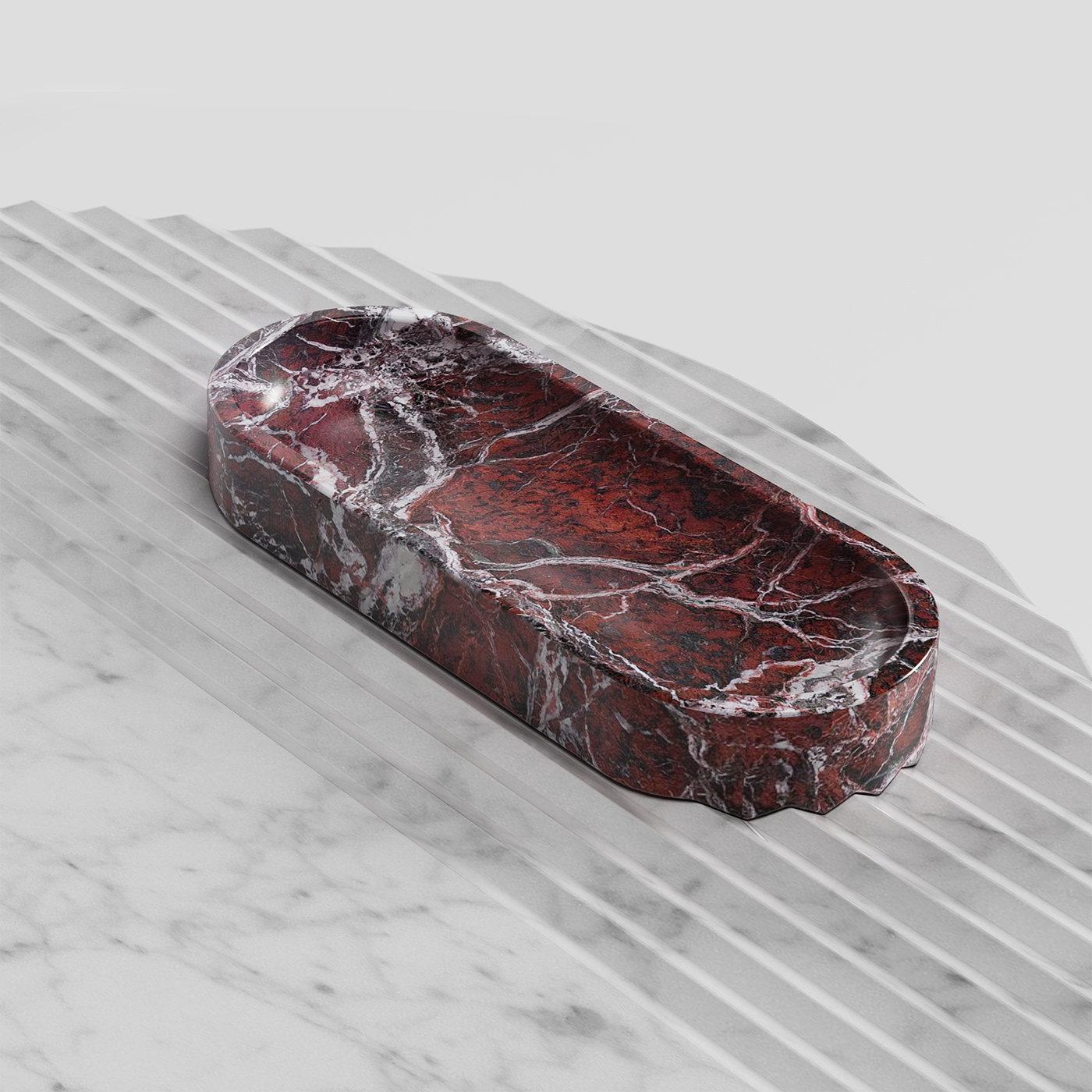 Equally ideal to display business cards in sophisticated waiting rooms or to offer pastries during a relaxing tea break, this elongated bowl with rounded extremities is crafted from prized red Levanto marble. Produced in Tuscany region, its