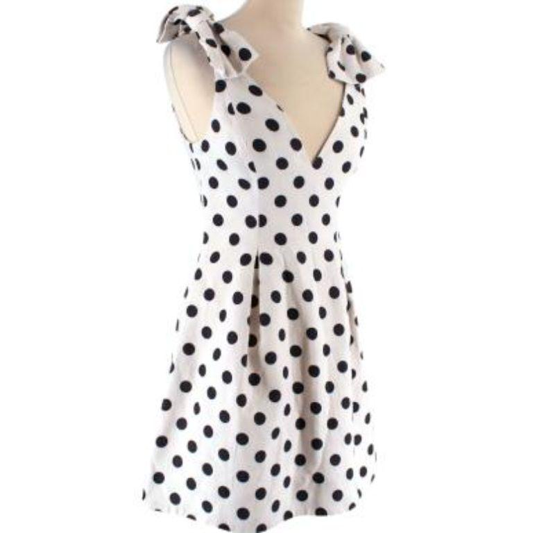 Zimmermann Black and White Polka Dot Linen Mini Dress

- Mid weight 
- All over polka dot pattern 
- Oversized bow shoulder detail 
- V neckline 
- Fitted body with A line skirt 
- Fully lined with white silk
- Back zip