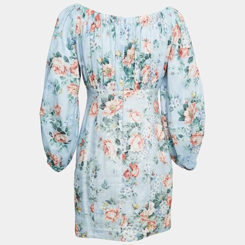 The Zimmermann mini dress is a stunning embodiment of effortless femininity. Crafted from soft linen  this dress features lovely floral prints on blue  creating a fresh and romantic aesthetic.