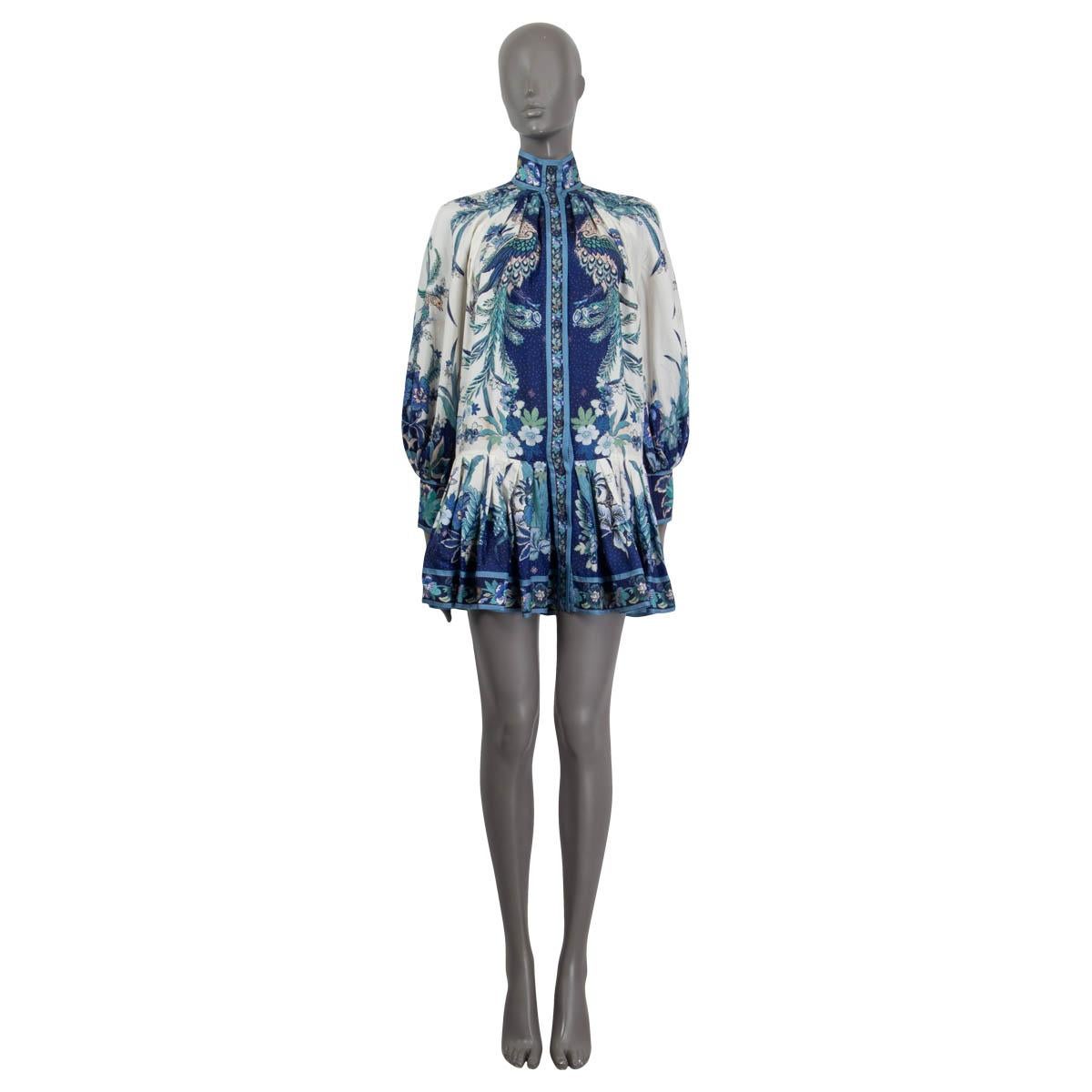 100% authentic Zimmermann glassy placement floral mini dress in off-white, navy, turquoise, sage and light blue silk (100%). Features a drop waist, zipped cuffs and a flared skirt. Has long raglan sleeves (sleeve measurements taken from the neck).