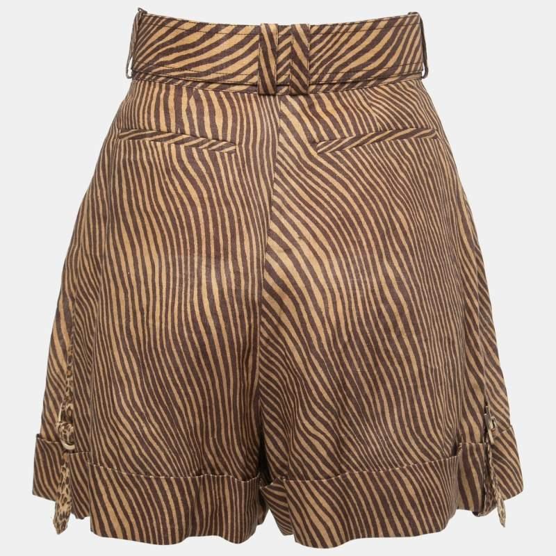 The Zimmermann shorts are a stylish summer essential. Made from breathable linen, they feature a high waist with a flattering belt, cuffed hems, and a chic animal print, combining comfort and fashion for a trendy warm-weather look.

Includes: tags