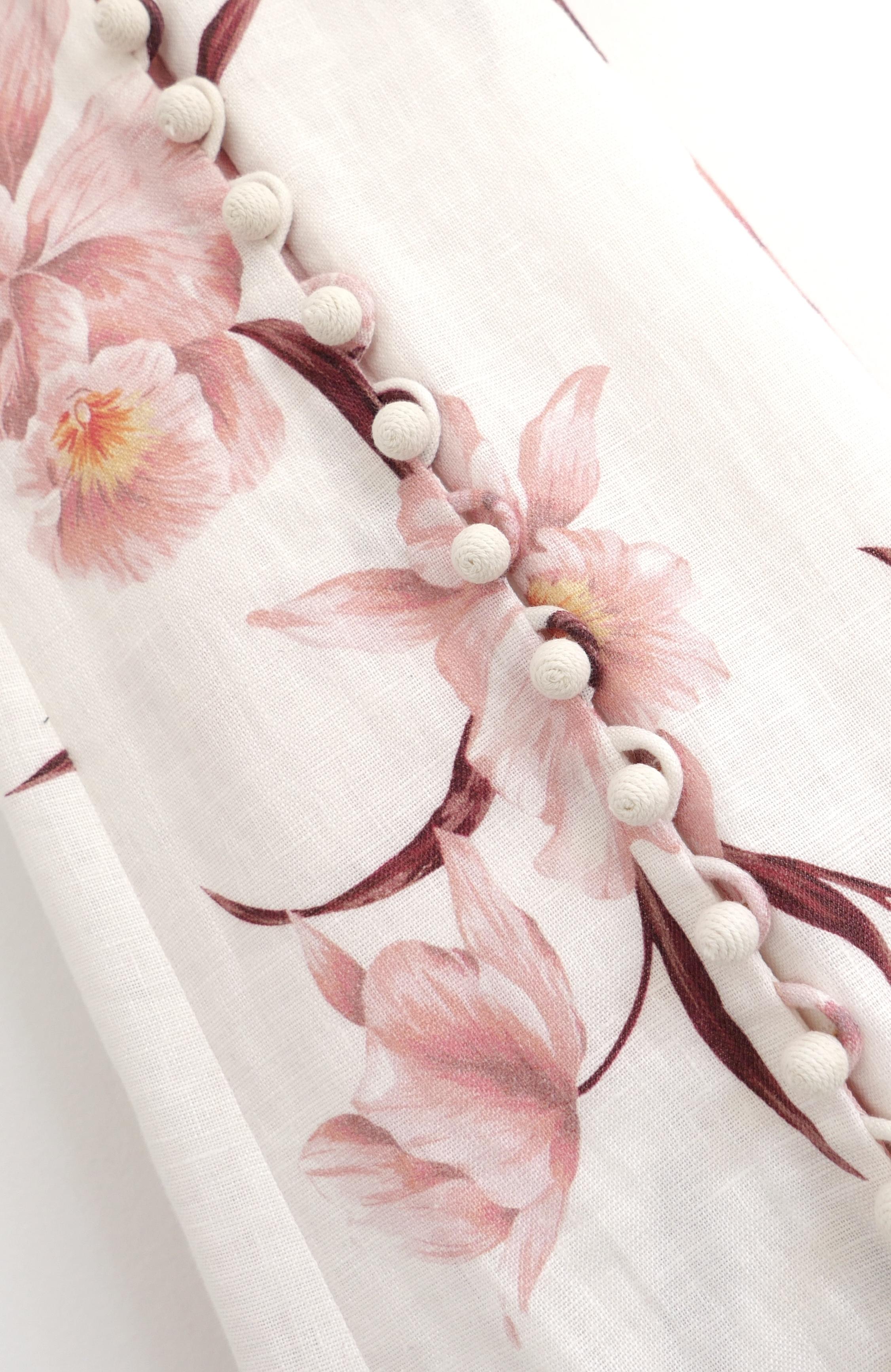 Gorgeous Zimmermann Corsage maxi dress. Bought for £1250 and worn a couple of times. 
Made from soft off white linen with a beautiful pale pink orchid print, it has n a-line floor length cut with half buttoned front and adjustable, ties back