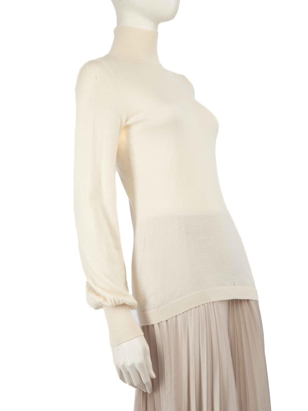 CONDITION is Very good. Minimal wear to top is evident. Minor hole near the waist on the front of the top on this used Zimmermann designer resale item.
 
 Details
 Ecru
 Wool
 Knit top
 Turtleneck
 Long sleeves
 
 
 Made in China
 
 Composition
