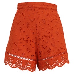 Pantalones cortos de cintura alta con ojales de Zimmermann, de algodón naranja