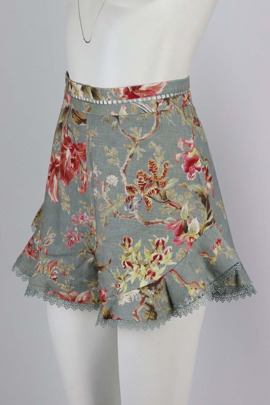 These shorts by Zimmermann are decorated with painterly blooms that look so pretty against the antique-blue background, outlined by ruffled trims, they have a high-rise waist and loose legs. Multicoloured linen-blend. Zip fastening at back. 52%