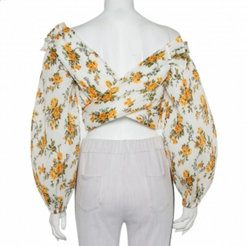 How gorgeous and stunning is this Zimmerman top! It is made of nylon and features a flattering silhouette. It flaunts a wrap style on the bodice and flouncy long sleeves. It comes equipped with a zip closure and can be paired with slim-fit jeans and