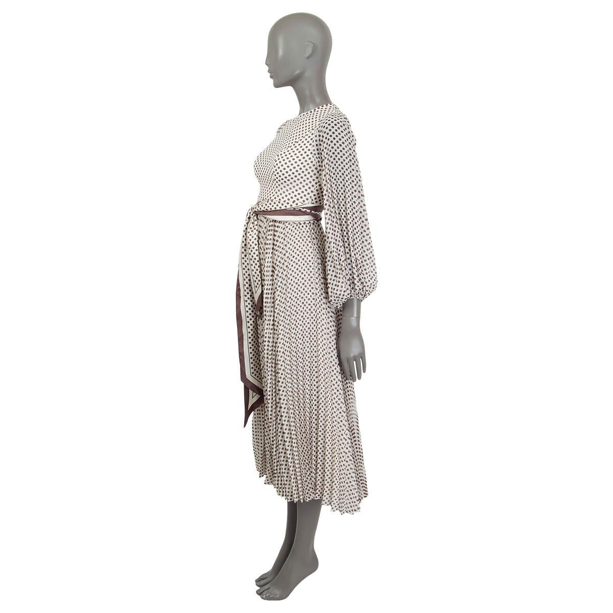 100% authentic Zimmermann Sunray belted long sleeve midi dress in off-white and brown polyester chiffon (100%). Features a detachable self-tie silk belt and a polka dot print. Opens with a zipper at the back. Lined in off-white viscose (100%). Has