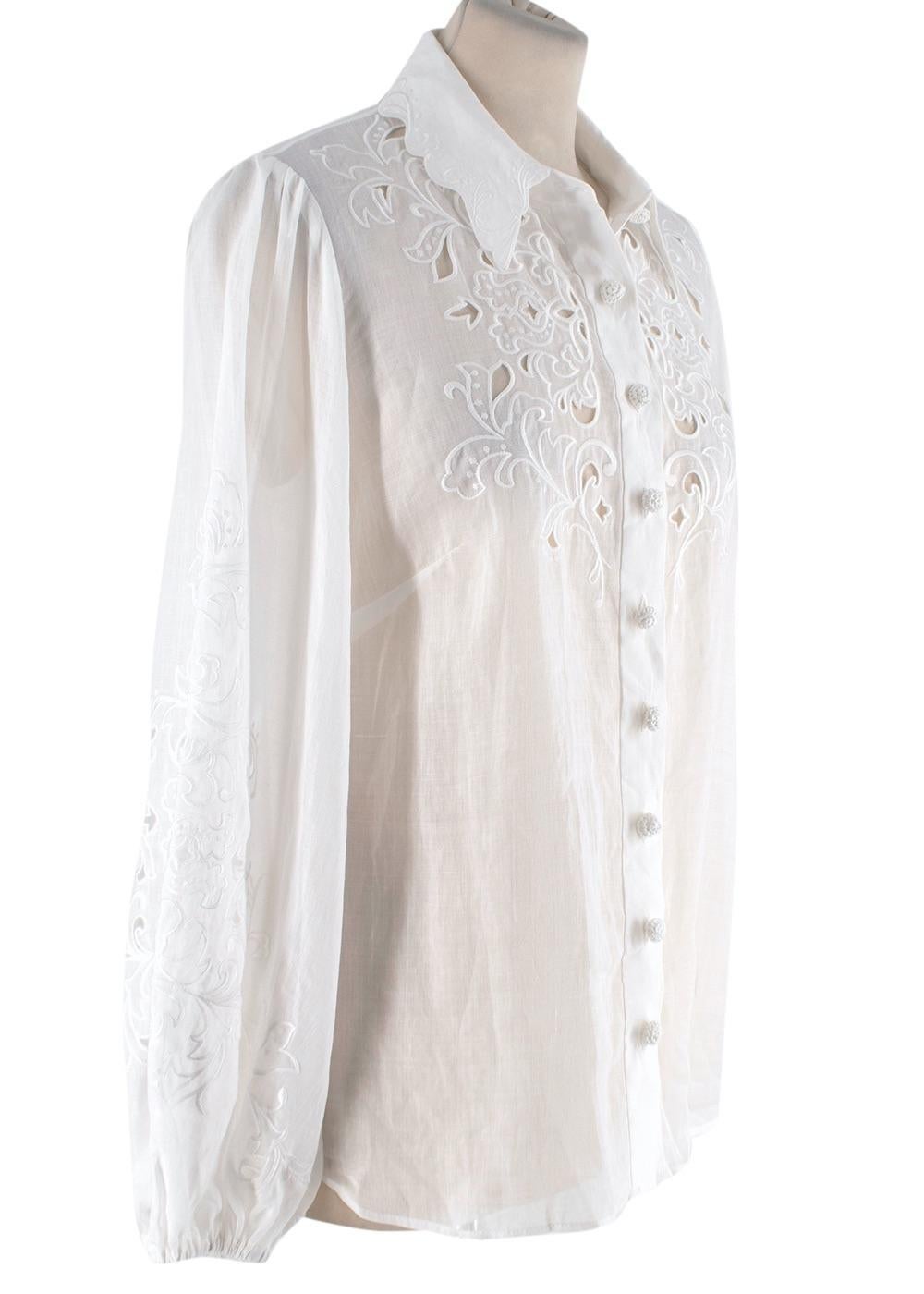 Zimmermann Ivory Linen Embroidered Nina Shorts & Blouse

- Classic collar blouse with cut work applique across the chest, and embroidery work over the scalloped collar, and balloon sleeves
- Decorative knotted buttons
- High rise tailored shorts
