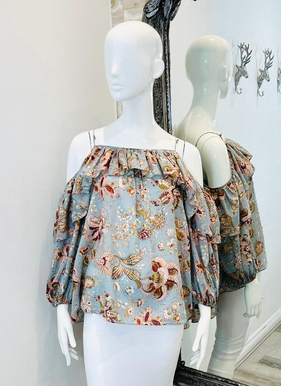 Zimmermann Off-The-Shoulder Silk & Cotton Top

Light dusty blue 'Pavilion' blouse designed with subdued coloured floral prints.

Detailed with off-the shoulder style and ruffled neckline.

Featuring loose fit silhouette, and three-quarter sleeves