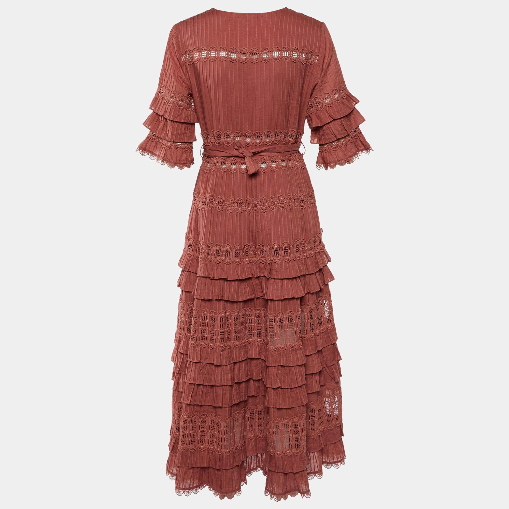 The Zimmermann dress is a stunning embodiment of effortless femininity. Crafted from soft cotton this dress features lovely border panels creating a romantic aesthetic. The tiered design adds playful movement while the flattering silhouette ensures