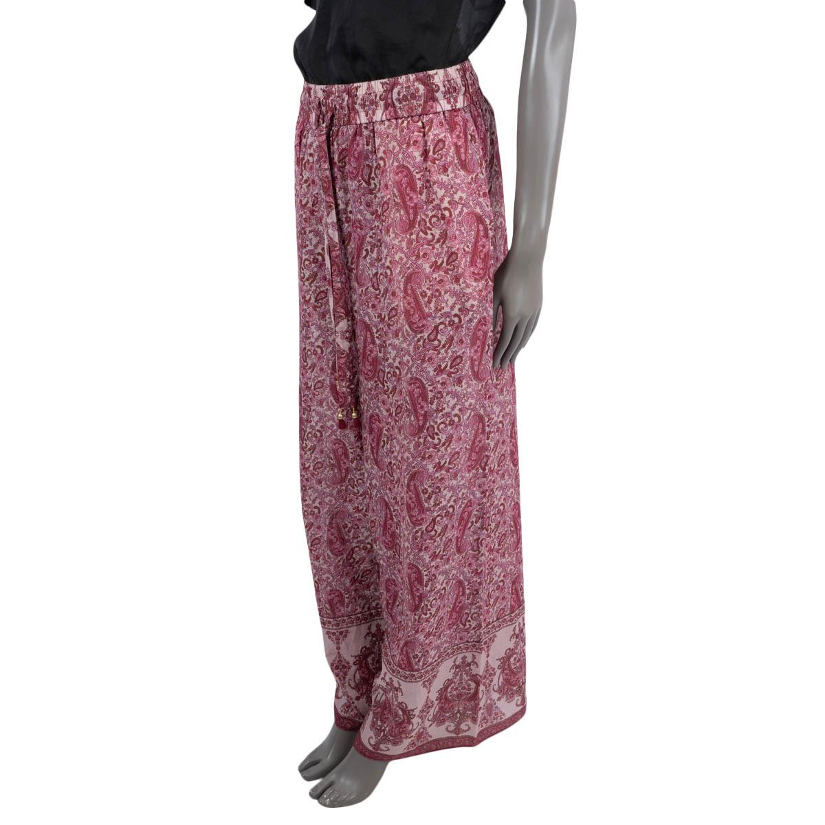 100% authentic Zimmermann Amari wide-leg pants in magenta pink cotton voile (100%). Features a paisley print, elastic waistband with drawstring and side seam pockets. Unlined. Have been worn and are in excellent condition.

Measurements
Tag