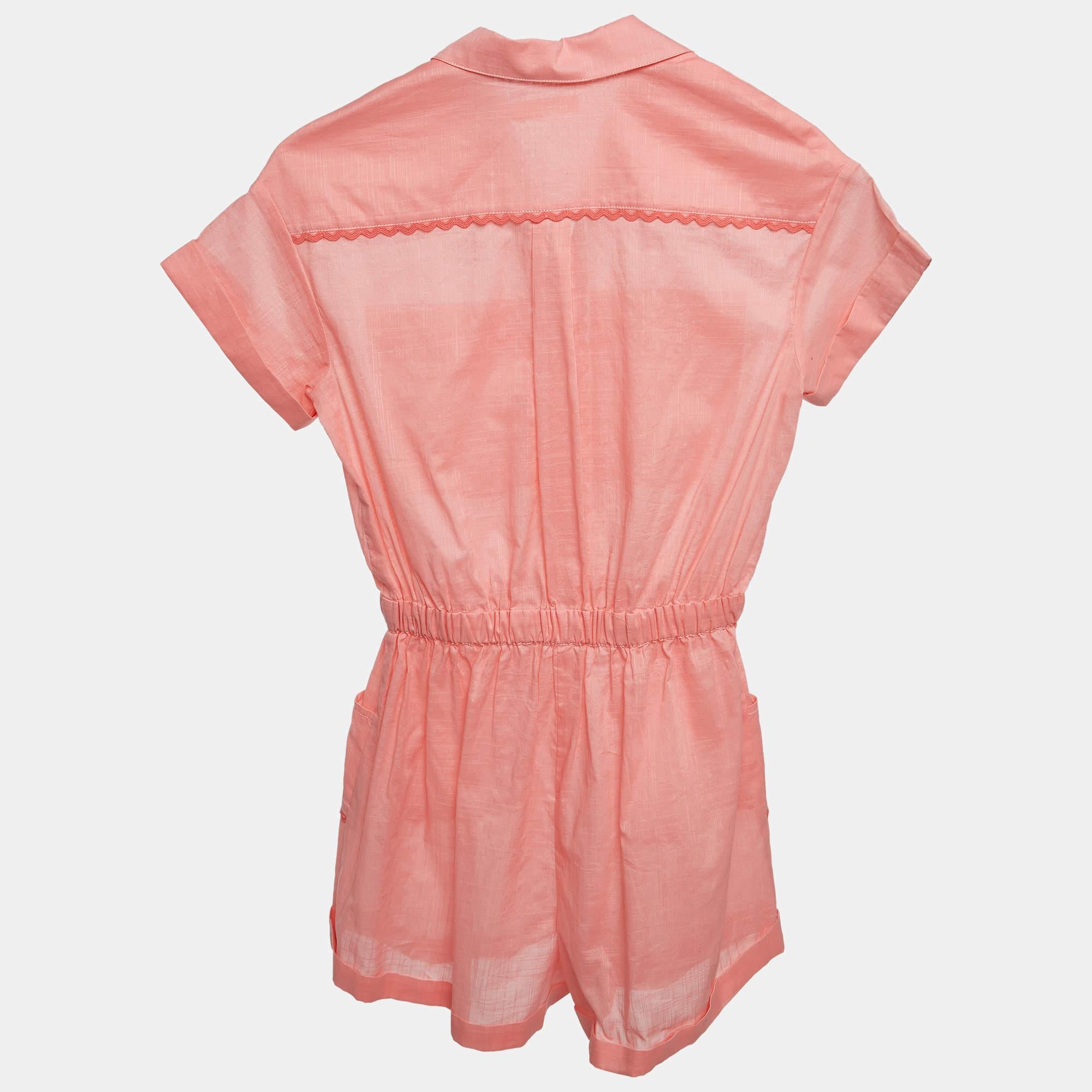 The Zimmermann playsuit is a charming one piece garment crafted from soft breathable cotton. Its feminine design features a flattering silhouette delicate pink hue and intricate detailing. With a comfortable fit and stylish aesthetic its perfect for