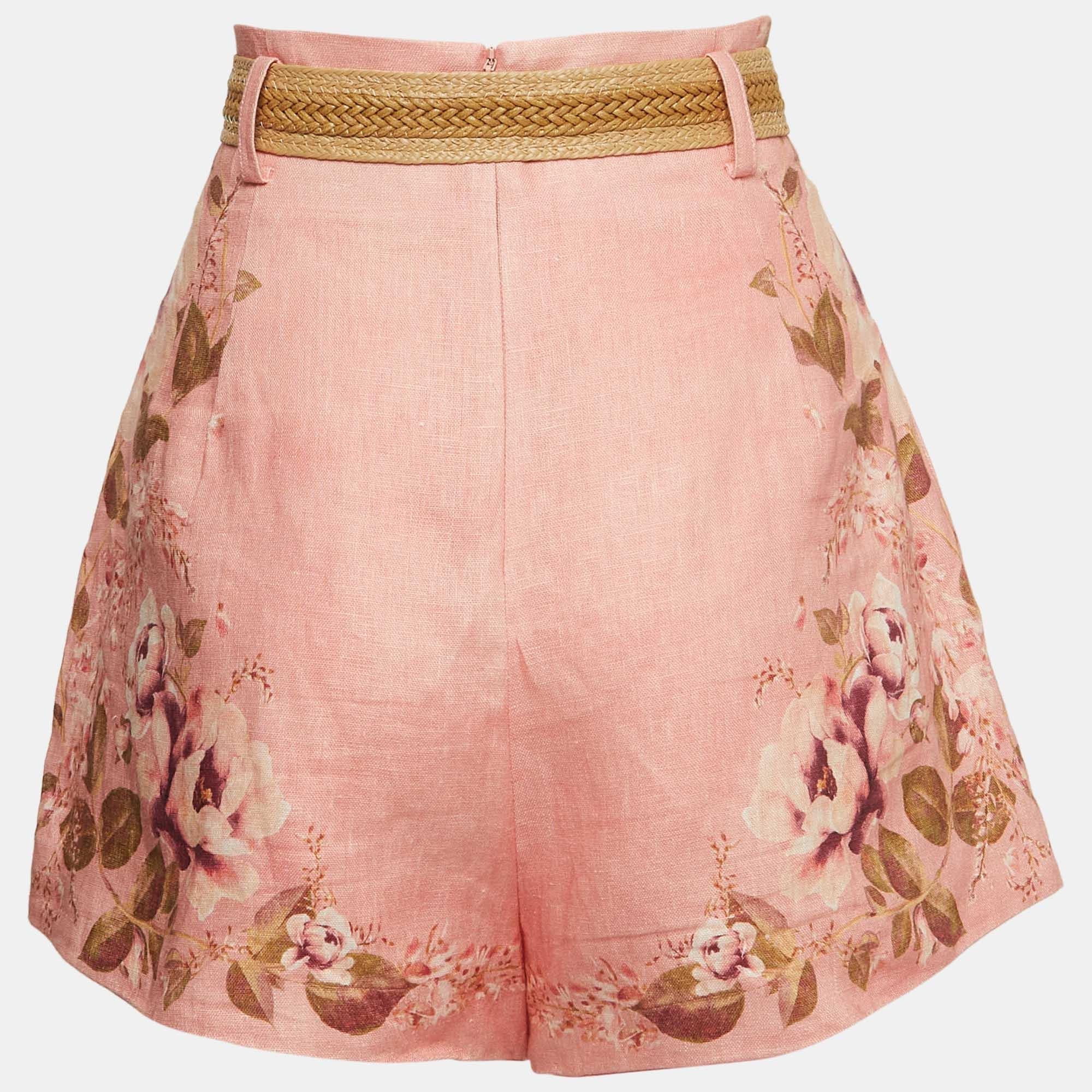 The Zimmermann shorts are a stylish summer essential. These shorts feature a delicate pink floral print on breathable linen fabric. They come with a matching belt for a flattering fit and a touch of elegance, making them perfect for casual