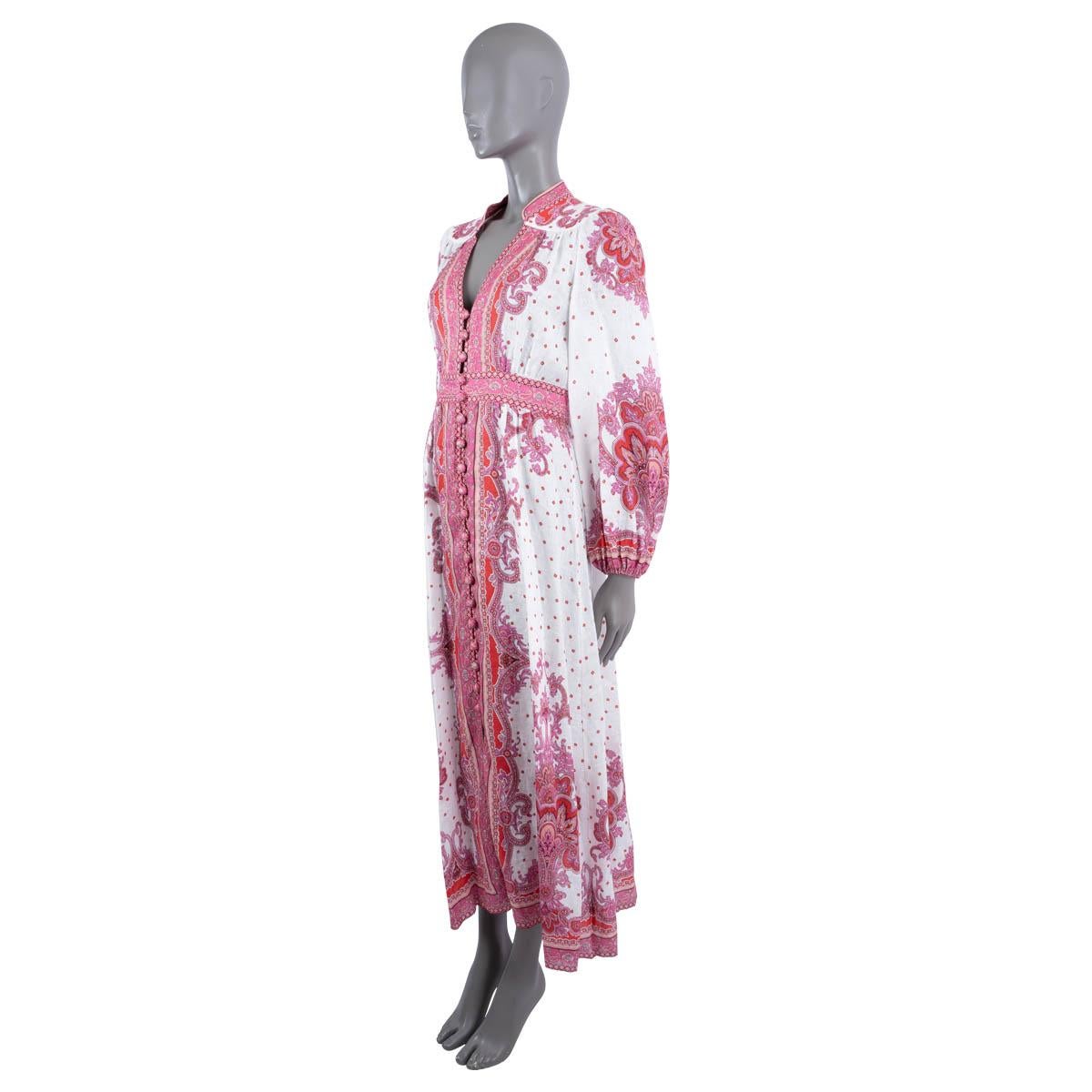 100% authentic Zimmermann Bells maxi dress in white, red and pink paisley printed linen (100%) - please note the content tag is missing. Features a V-neck with band collar, button front with high-slit and elastic cuffs. Opens with a conclealed
