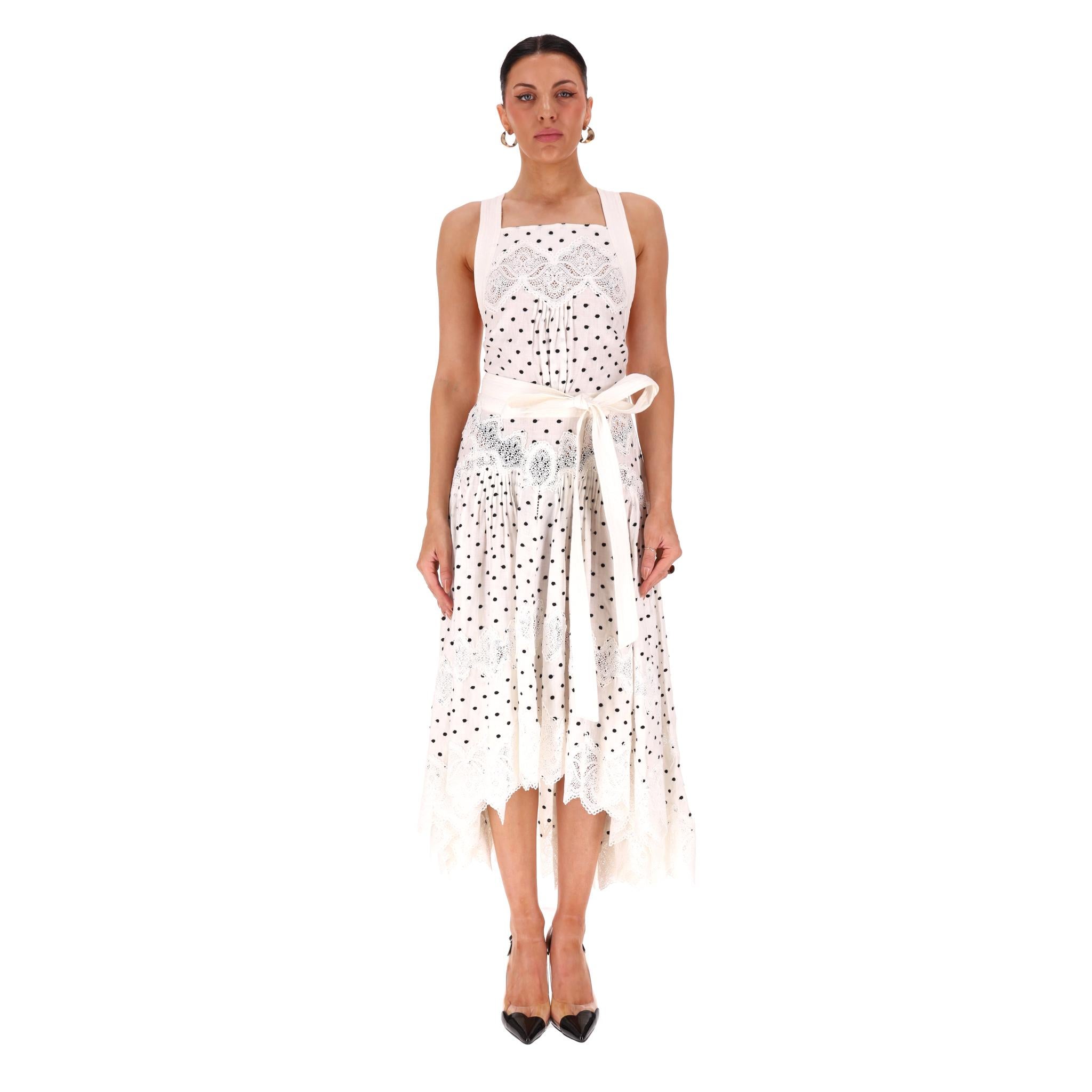 Zimmermann Polka-Dot Lace Embellished Apron Linen Dress

White summer dress fully crafted from linen with a black polka-dot pattern.

Embellished with white lace panels, tie-up waist and criss-cross strap detail at the back.

Sleeveless design with