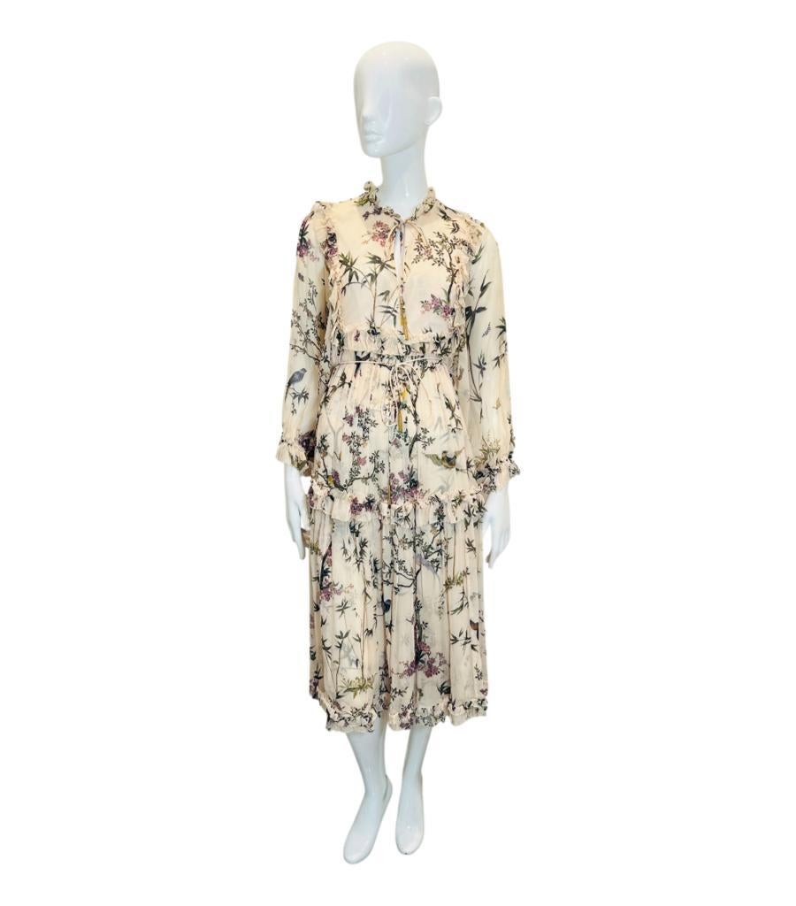 Zimmermann Silk Ruffle Dress
Ivory midi dress designed with pastel floral pattern throughout gold tassel detailing to the high frilled neckline.
Featuring ruffle accents, self-tie waist and elasticated cuffs.
Size – 2 - M
Condition – Good/Very Good