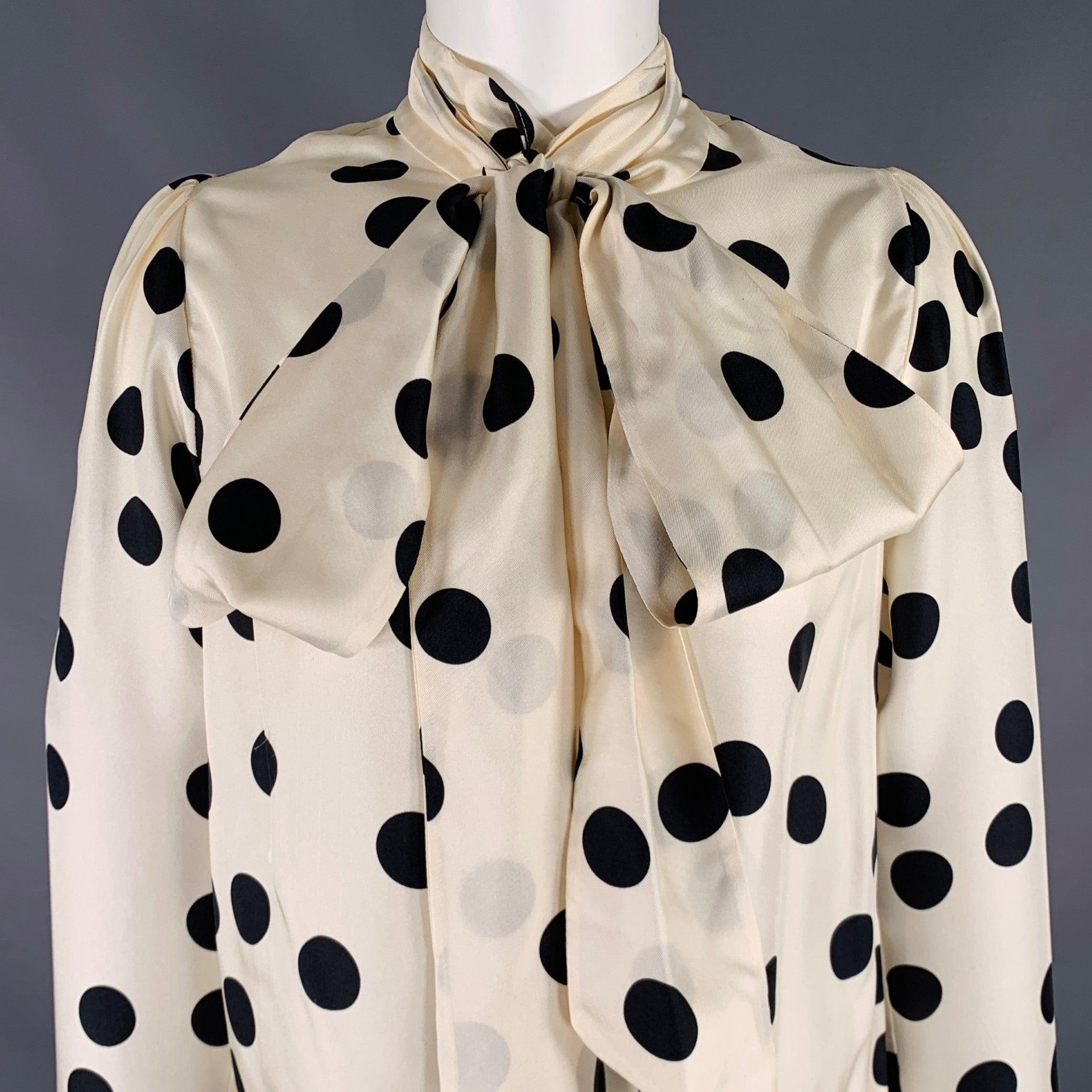 ZIMMERMANN blouse
in a
beige and black silk fabric featuring a polka dot pattern, neck bow detail, and back zipper closure.Very Good Pre-Owned Condition. Very minor mark on bow, which can be hidden by styling. 

Marked:   1 

Measurements: 

