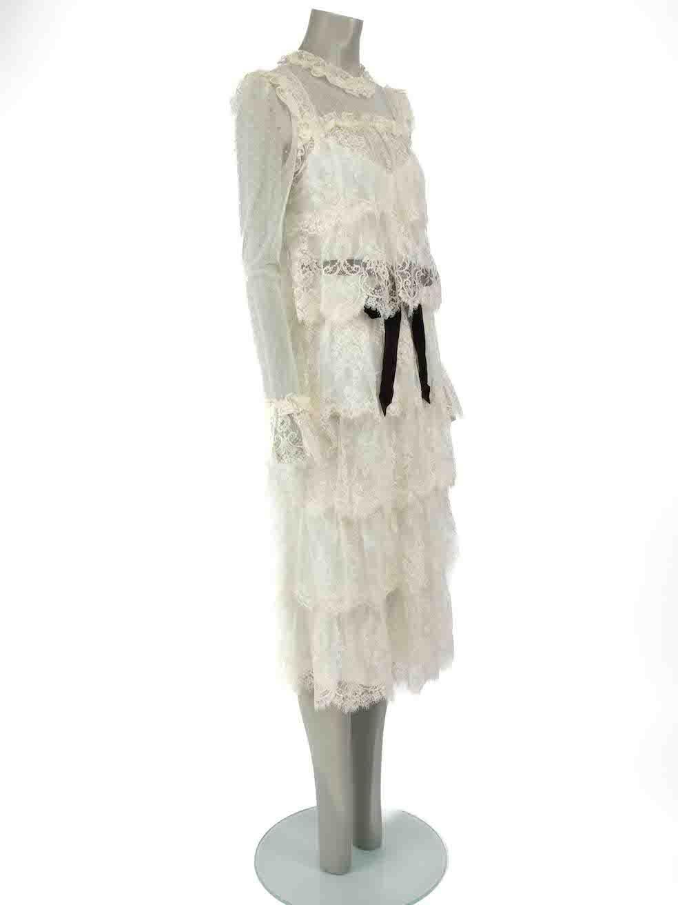 CONDITION is Never worn, with tags. No visible wear to dress is evident on this new Zimmermann designer resale item.
 
 
 
 Details
 
 
 White
 
 Lace
 
 Dress
 
 Long sleeves
 
 Round neck
 
 Front button fastening
 
 Belted
 
 Midi
 
 Slip under