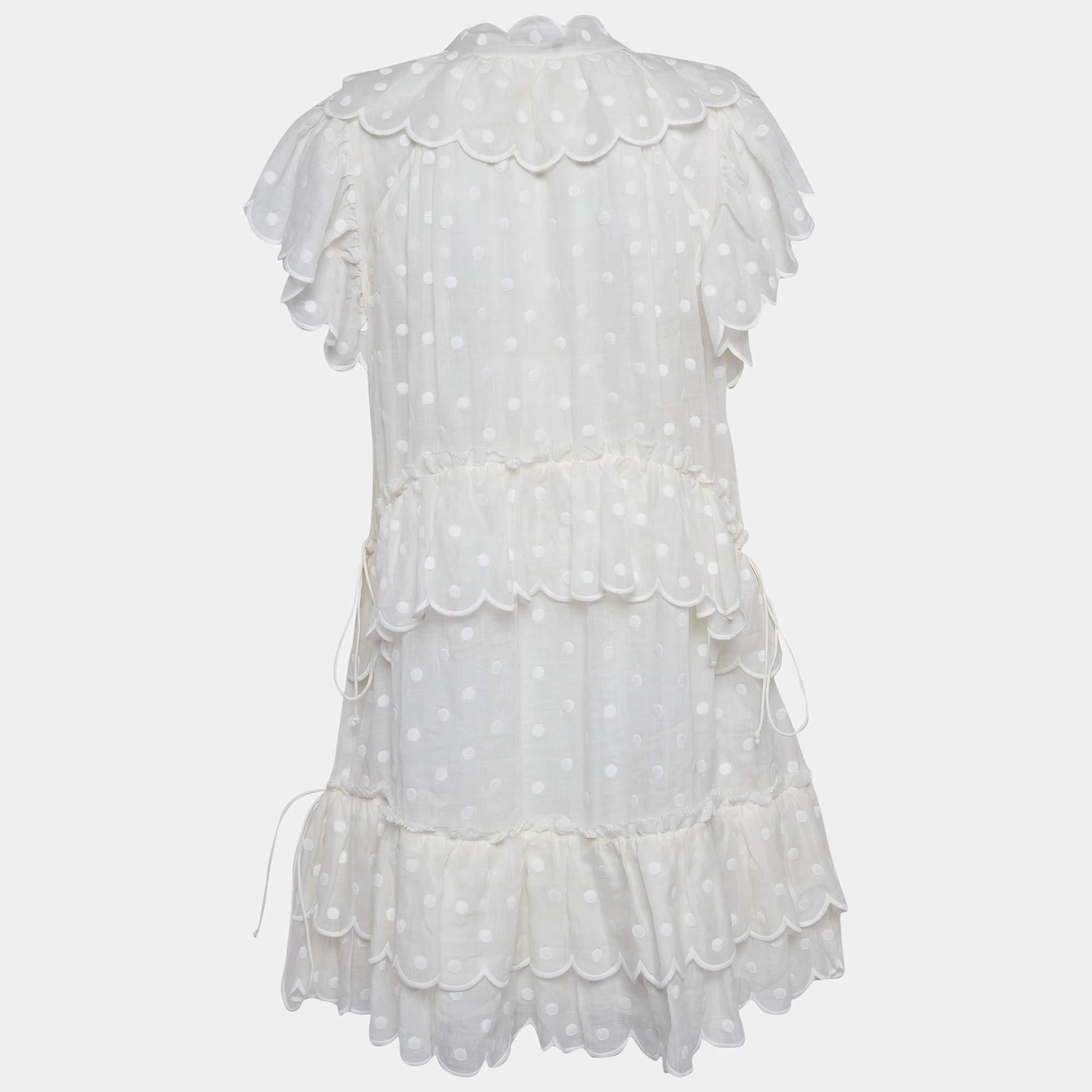 Dainty yet dynamic, the Zimmermann mini dess exudes charm with its delicate white polka dots dancing across airy ramie fabric. The tiered design adds playful movement, while intricate embroidery adds a touch of artisanal craftsmanship. Perfect for a