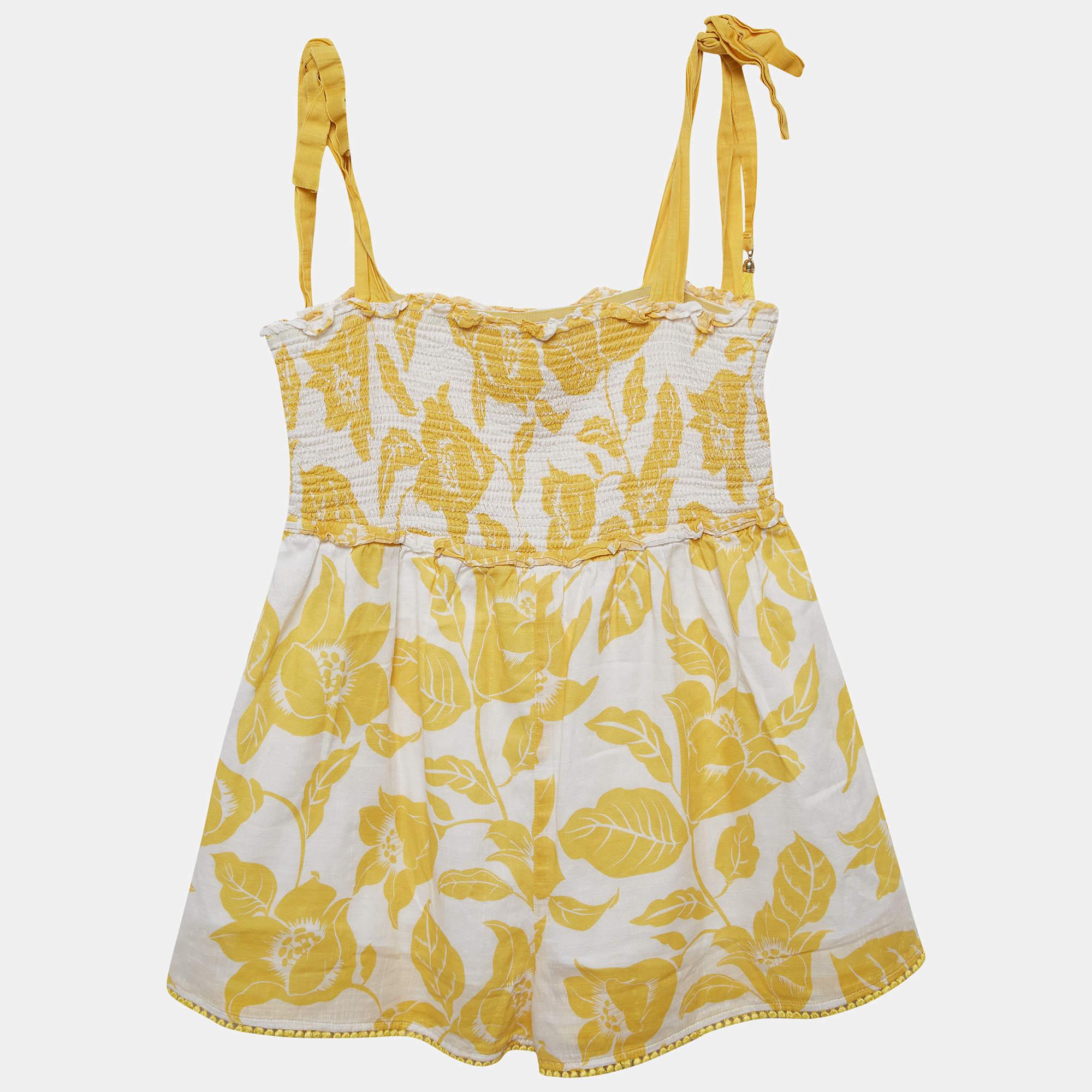 The Zimmermann playsuit is a chic and playful one piece garment crafted from lightweight cotton. Its white and yellow floral print exudes a summery vibe while the design features a flattering silhouette adjustable straps and a comfortable fit for
