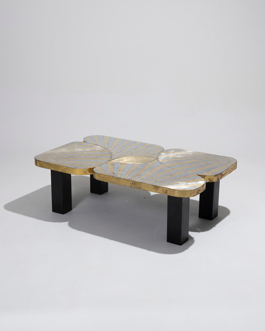 Zinc and brass marquetry coffee table, unique piece made by the French artist of Serbian origin Marko in the 90s. Free in shape, the marquetry strip tray is surrounded by a large brass band and set with a shape of an eye in the center. The four