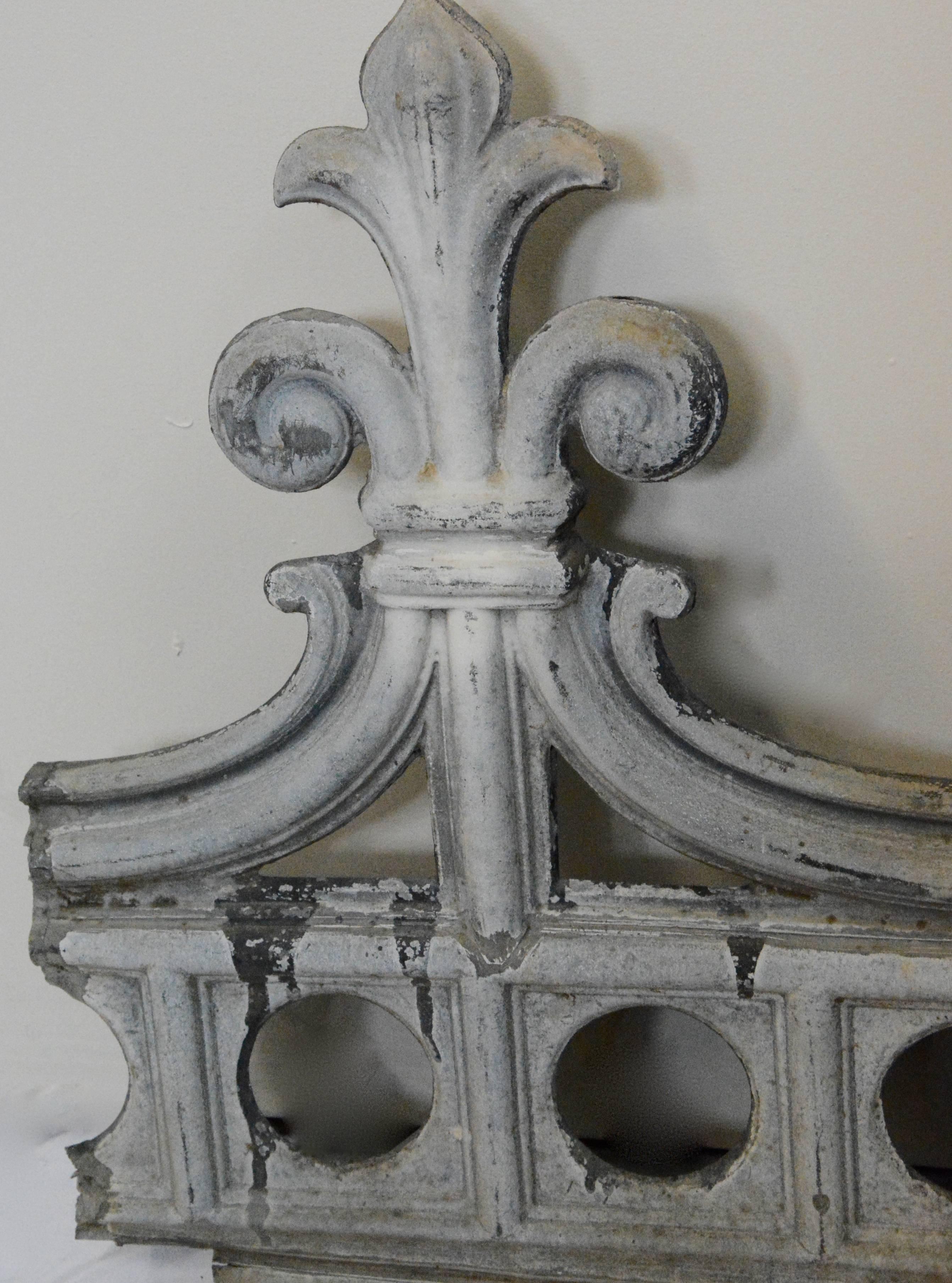 Featured is a nice metal architectural fragment that will make a unique wall decor piece. This piece features a row of circular cutouts topped with elegant curves and uprights with fleur-de-lis finials. There are no apparent maker’s marks, and