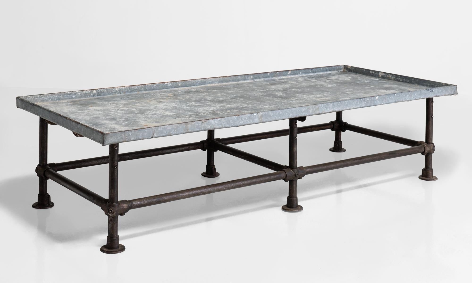 Industrial coffee table with iron base and zinc top.