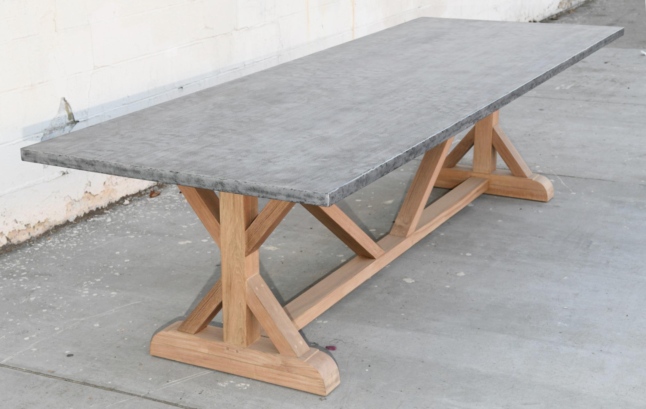 Designed to withstand any climate, this zinc top teak table is seen here in 120