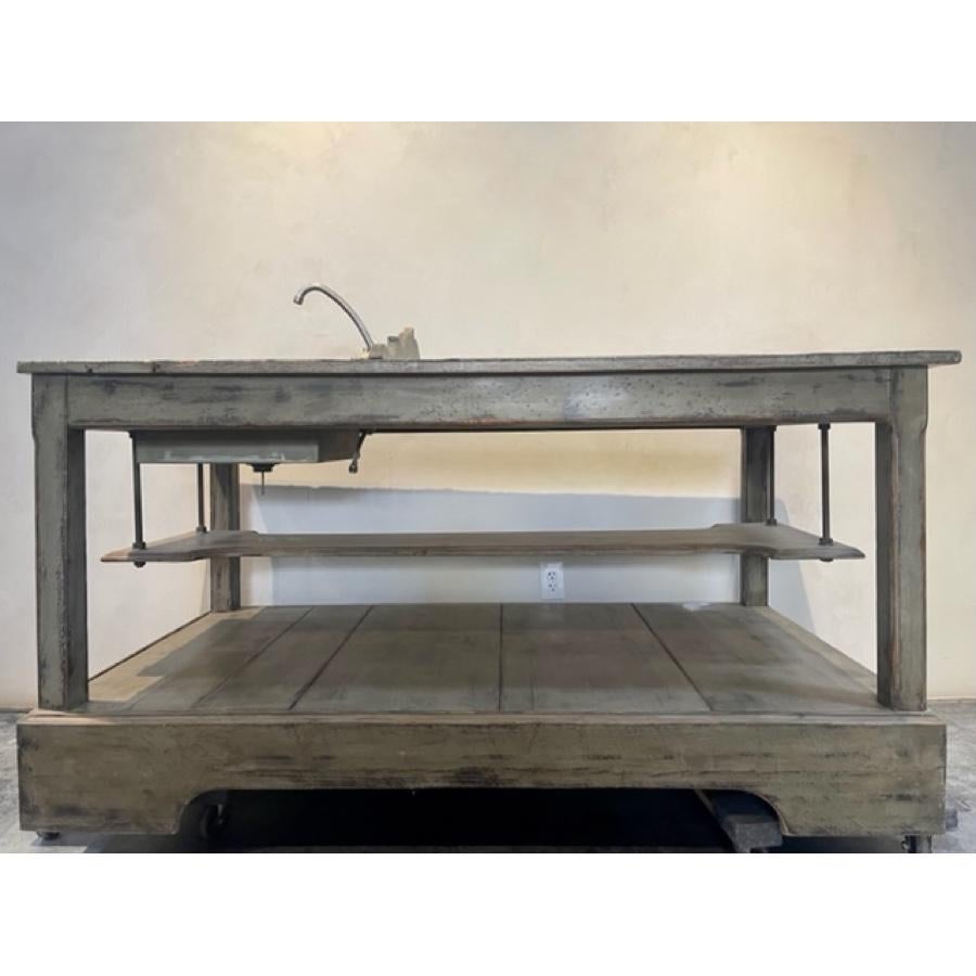 Zinc Top island with Integral sink on one end. Great for Island or Bar. Open Below with hanging shelf from metal supports. Brass faucet and metal sink included. Splash guard behind sink. 
Painted and Glazed wood with distressing. 

Item #: